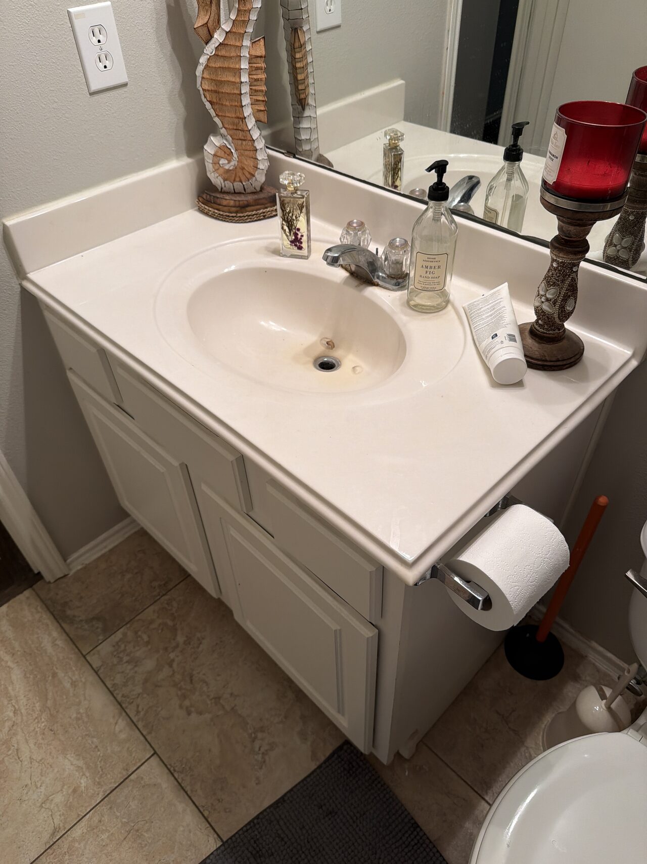 Existing bathroom vanity condition documented to compare sink placement, counter overhang, and cabinet fit before detail review for a Joel Hodge project.