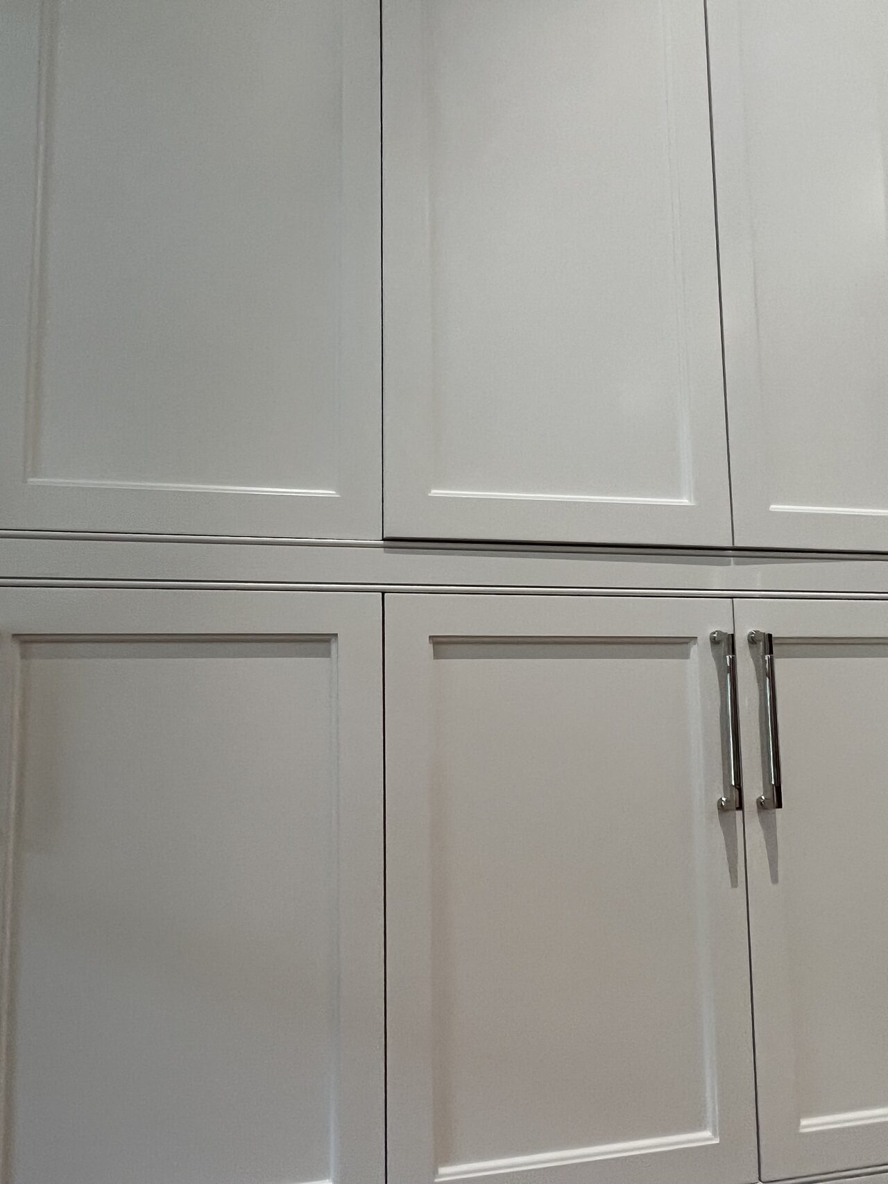 Tall cabinet and vanity side detail showing vertical door alignment, drawer spacing, and finish trim transitions for a Joel Hodge project.