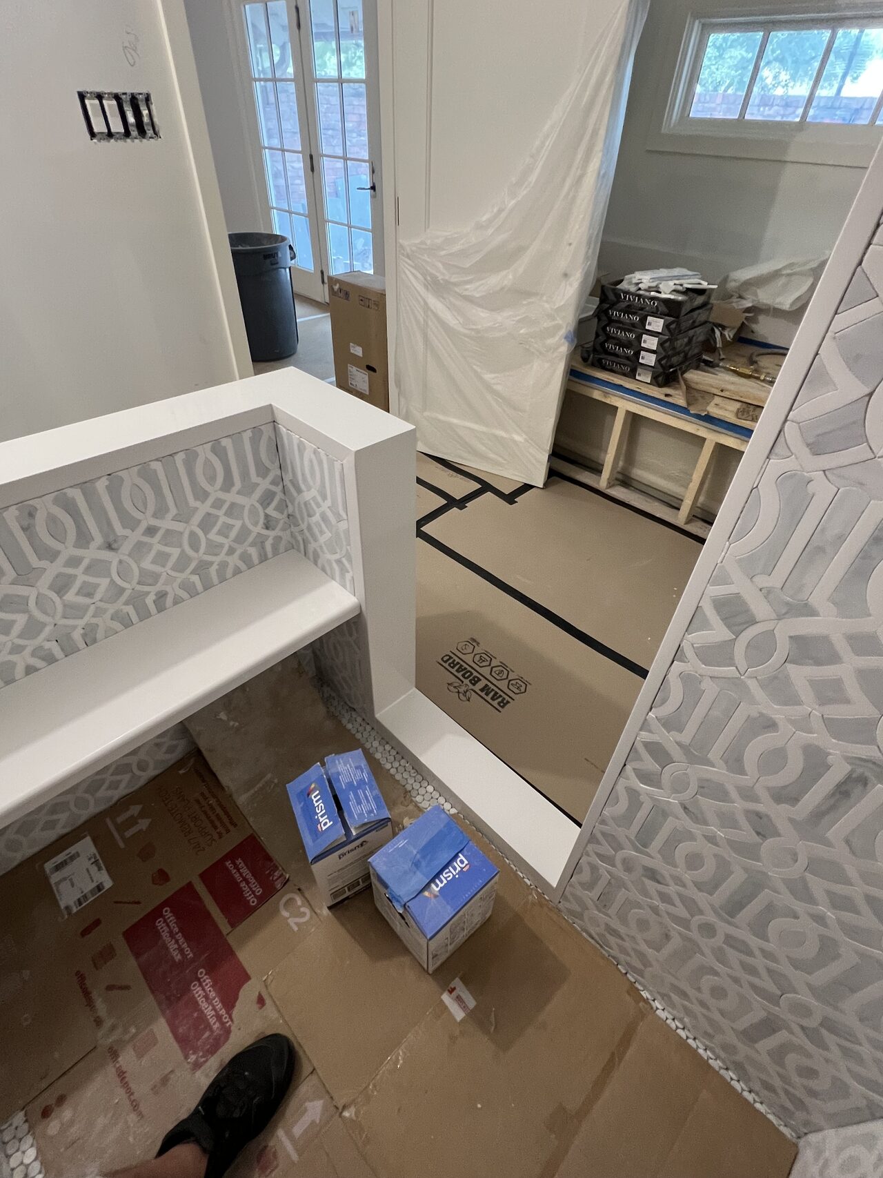 Bathroom work zone with materials staged and floor protection in place during vanity and tile coordination for a Joel Hodge project.