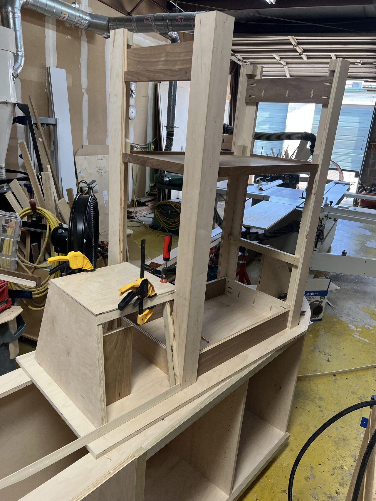 Curved millwork form stood on the shop bench while the radius template and laminated parts were being checked for a Joel Hodge project.