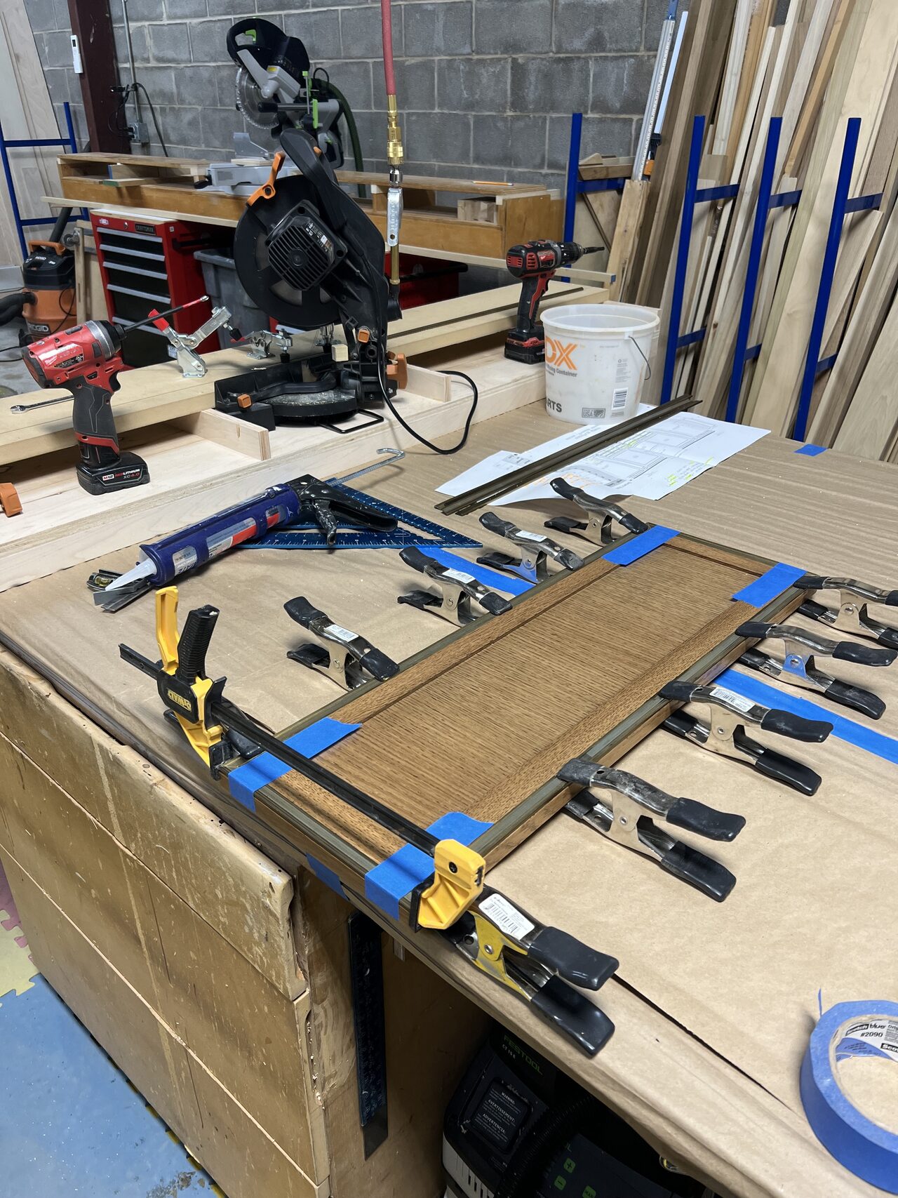 Routed wood pieces and layout strips clamped on the bench before the curved assembly was built up for a Joel Hodge project.