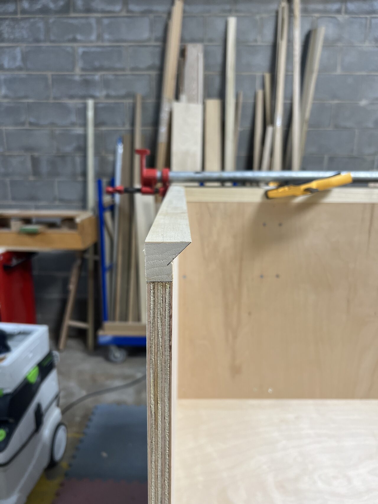 Side view of the curved cabinet form showing support blocks, panel thickness, and radius buildup for a Joel Hodge project.