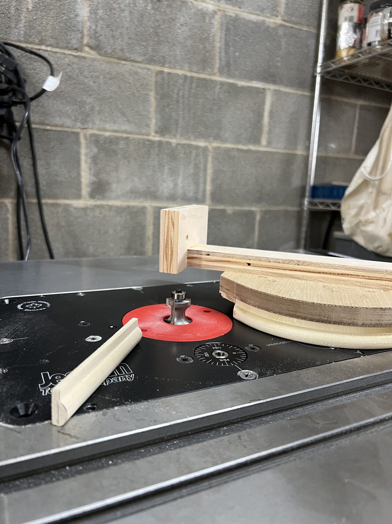 Profile bit and sample setup used to confirm the curved trim edge before running the final parts for a Joel Hodge project.