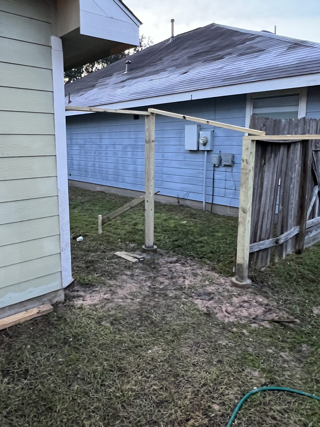 Existing gate opening documented to confirm post locations, swing clearance, and fence-to-wall alignment for a Joel Hodge project.