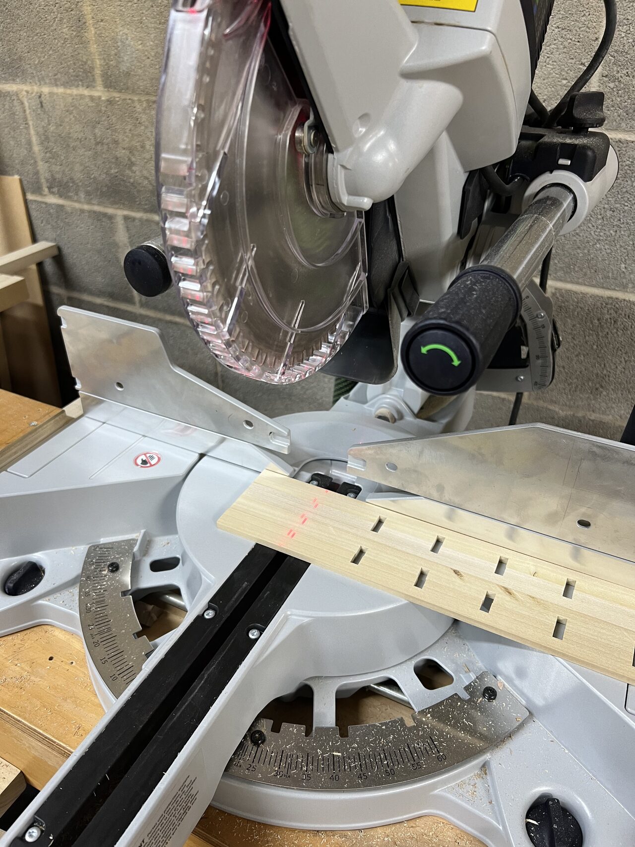 Miter saw setup used to cut gate slats and rail pieces to length for the exterior wood assembly for a Joel Hodge project.