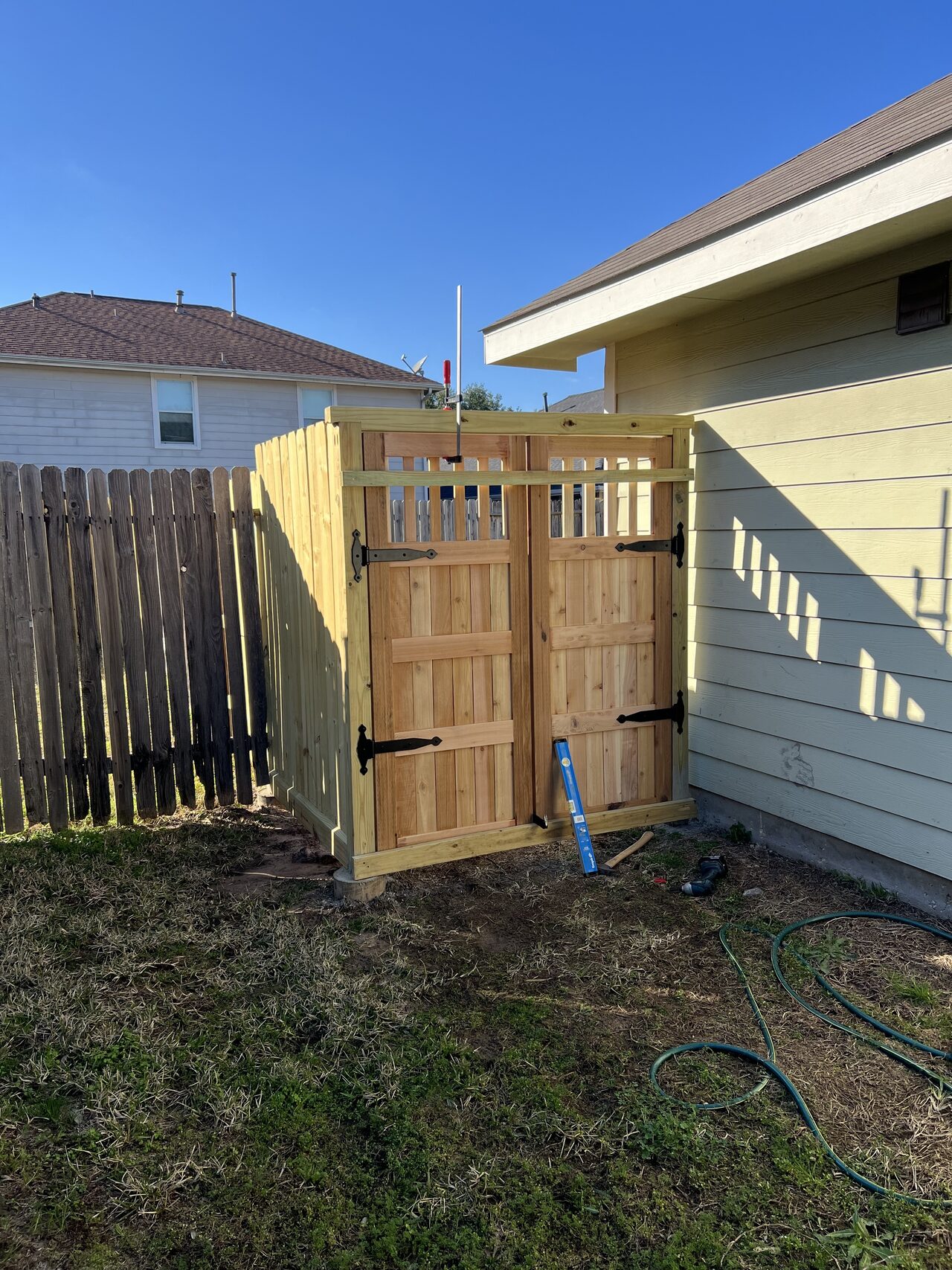 New gate installed in the side-yard opening with fence alignment and ground clearance checked in daylight for a Joel Hodge project.