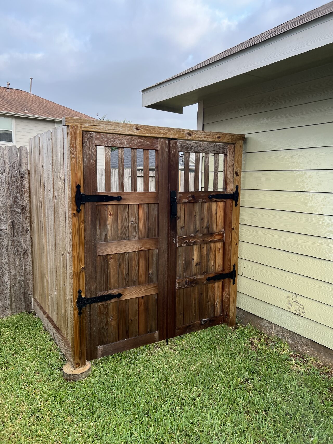 Completed double gate and exterior panel set between the fence and wall after final fit review for a Joel Hodge project.