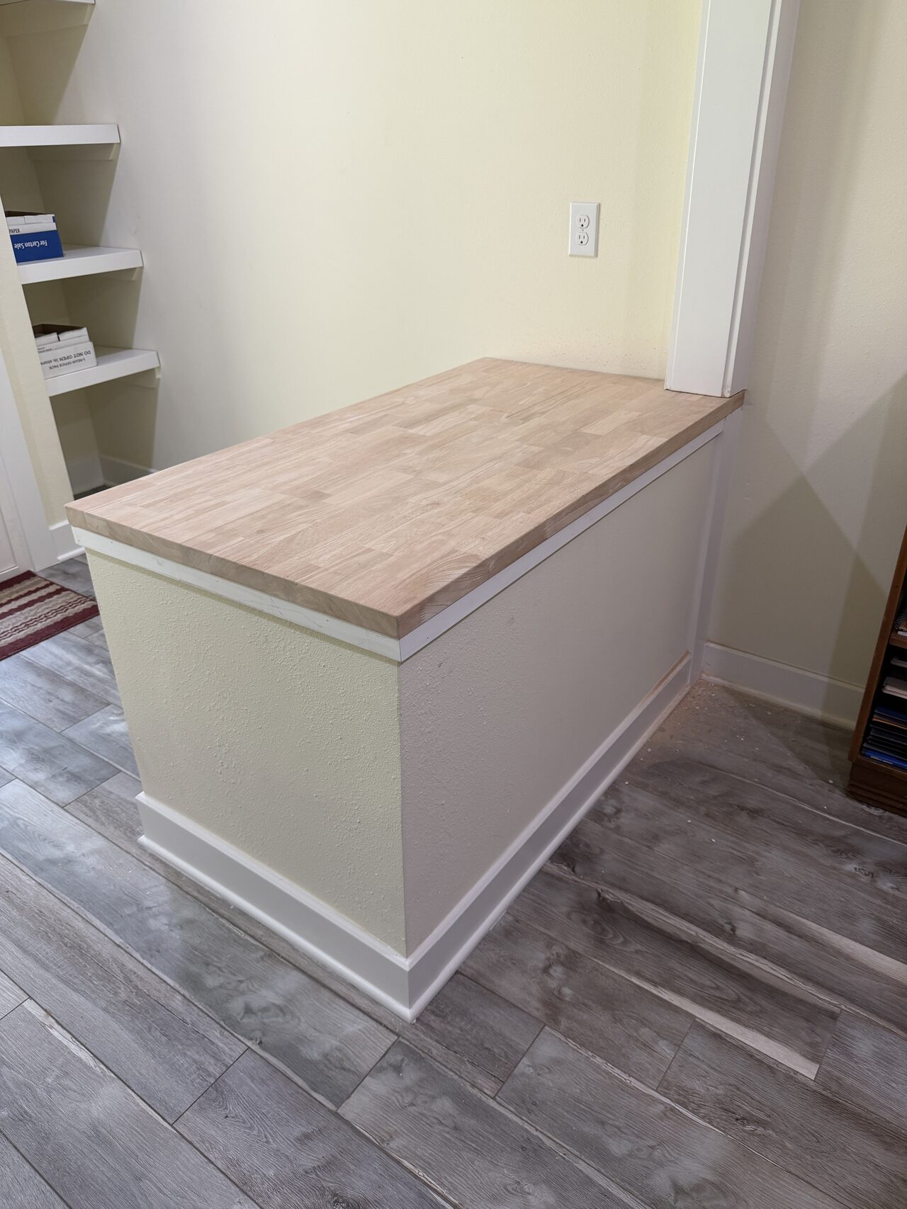 Low window-seat style built-in with wood top and base storage checked for wall-to-wall fit for a Joel Hodge project.