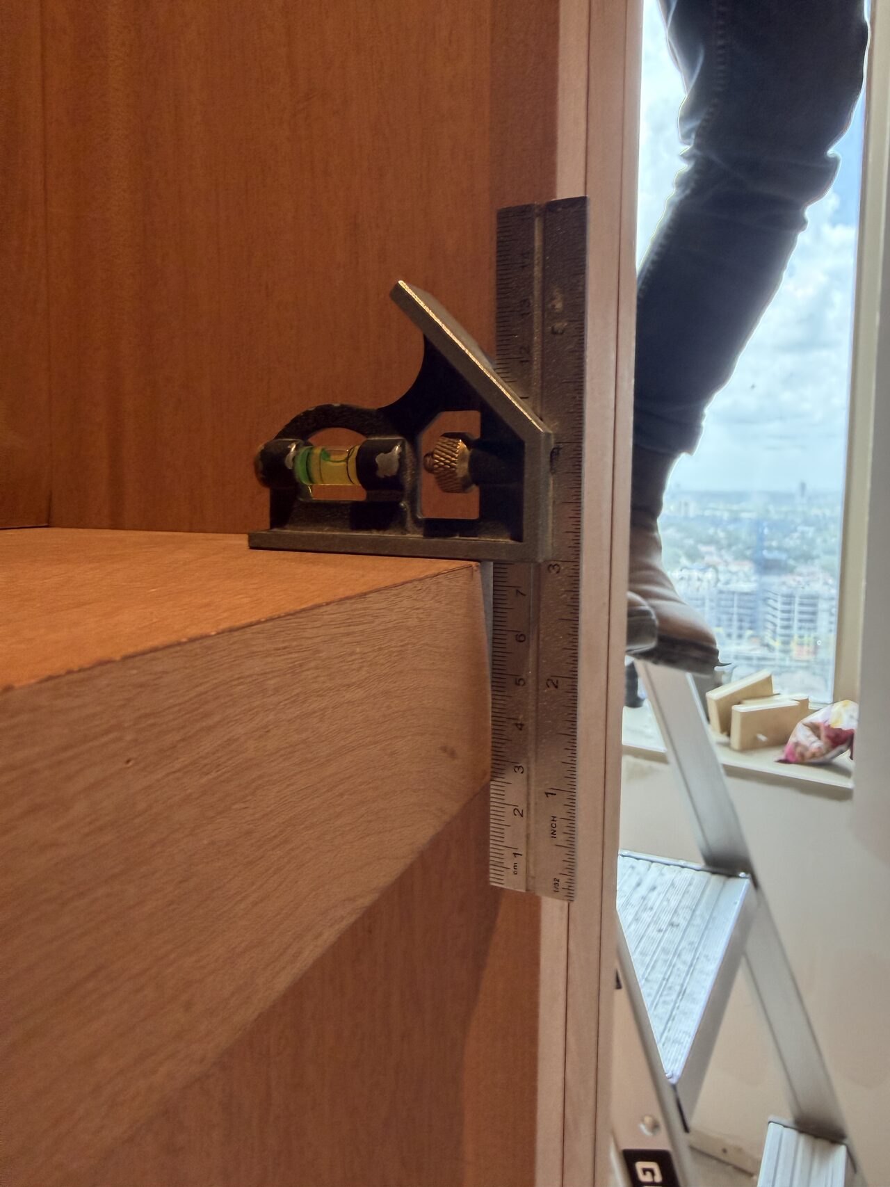 Close-up of cabinet side hardware and scribe detail near the window opening for a Joel Hodge project.