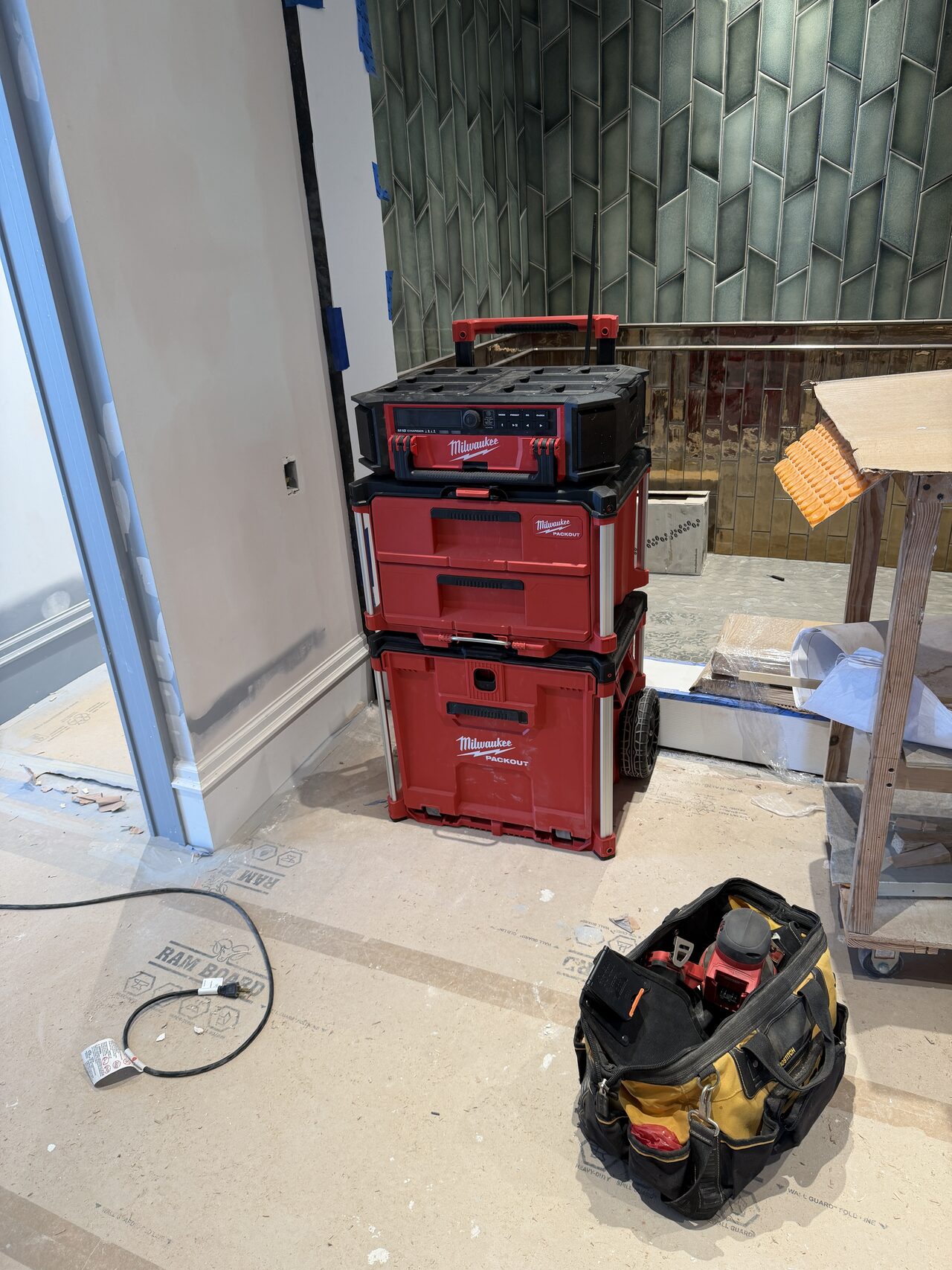 Protected room with tool carts and staging visible while the custom cabinetry was being installed for a Joel Hodge project.