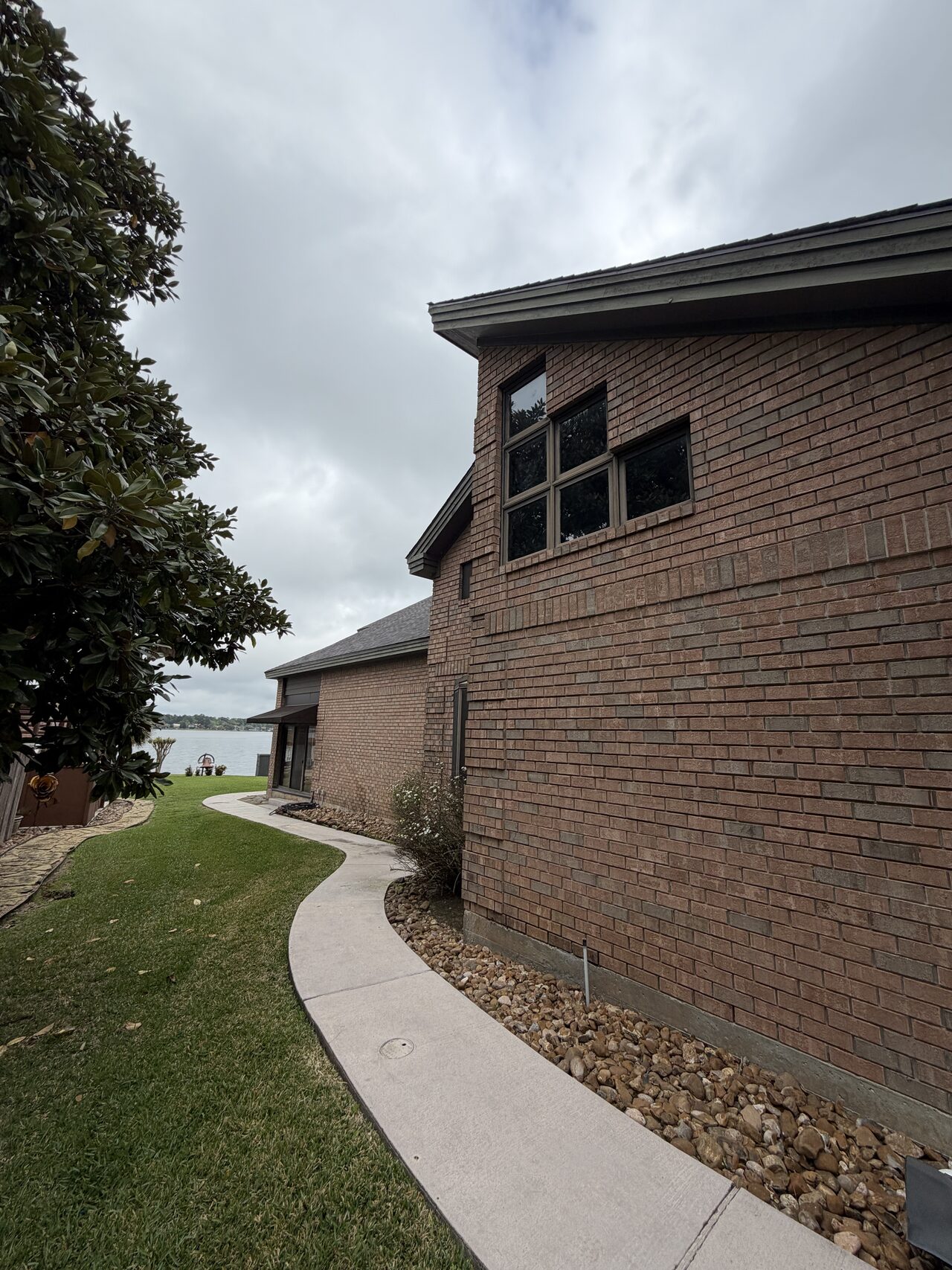 Side elevation walkway and window line documented for exterior siding and trim condition review for a Joel Hodge project.