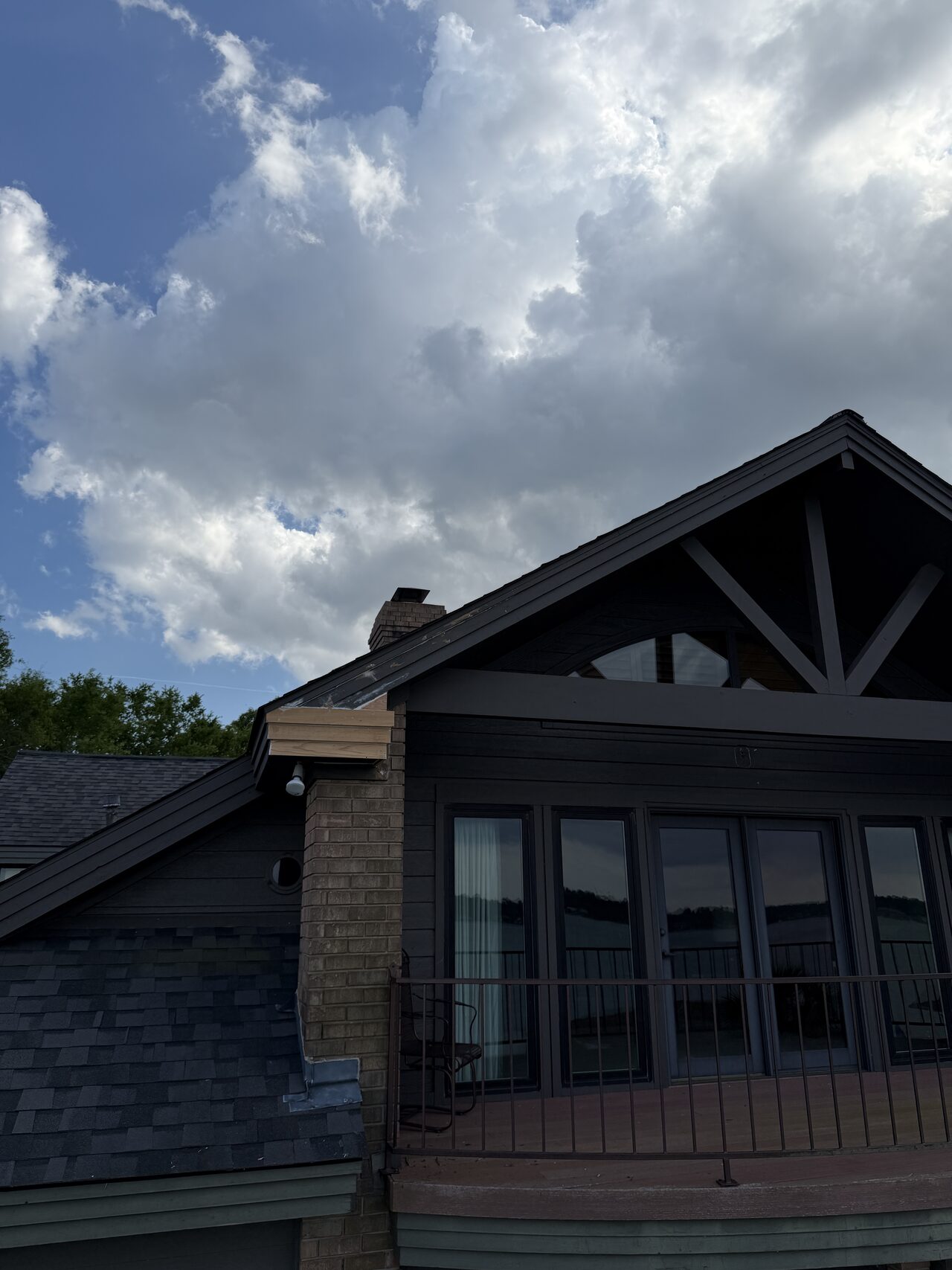 Dark gable elevation reviewed for trim proportions, window alignment, and roofline condition for a Joel Hodge project.