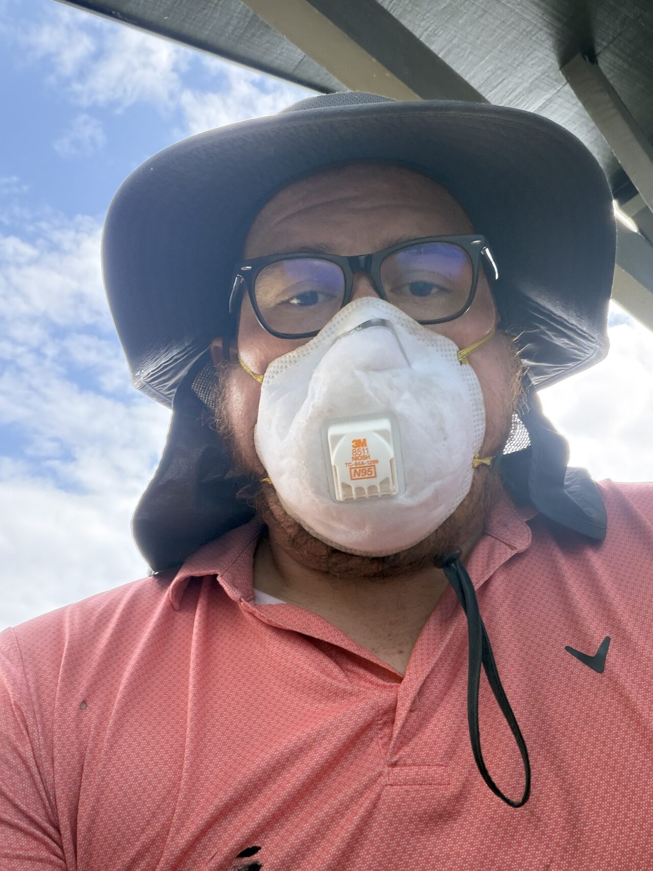 Respirator and eye protection documented during the exterior field review where dust or debris exposure was possible for a Joel Hodge project.