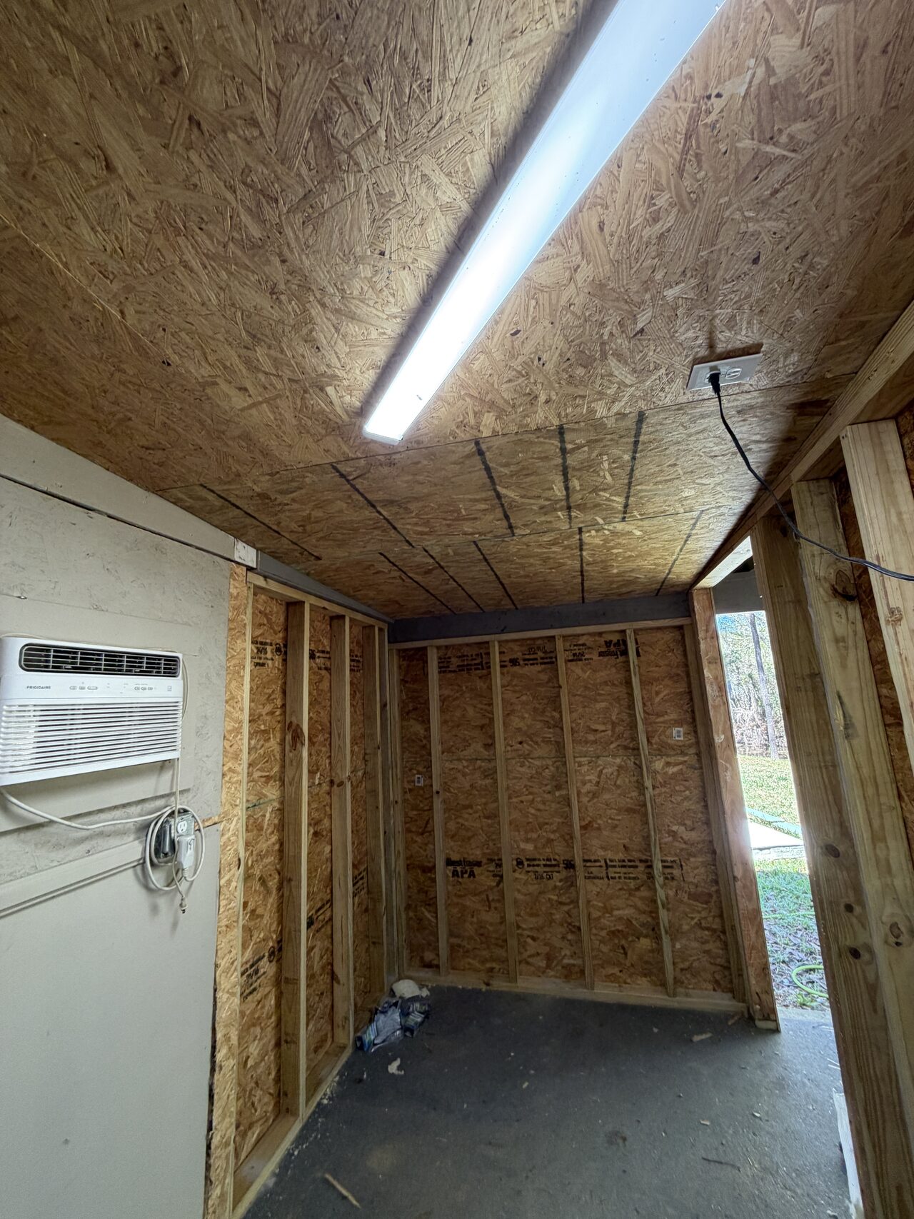 Interior framed room with OSB ceiling and wall sheathing reviewed before finish trim installation for a Joel Hodge project.
