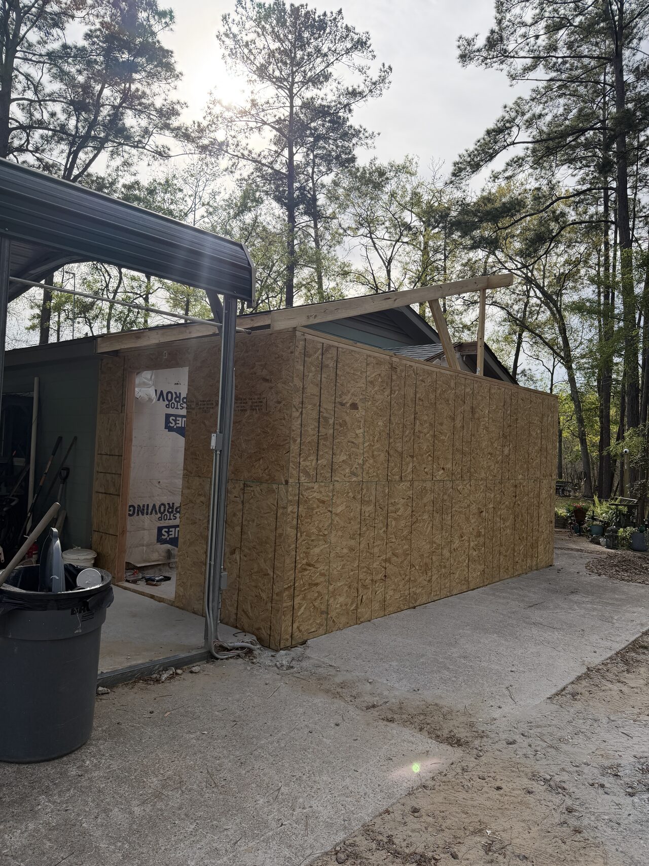 Sheathing panel being positioned on the exterior wall to close in the opening for a Joel Hodge project.