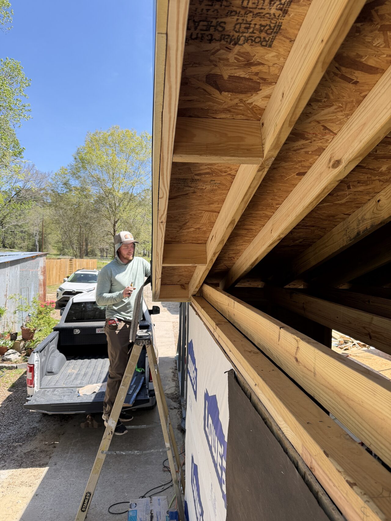 Long eave framing run documented to coordinate siding, trim, and weather protection for a Joel Hodge project.