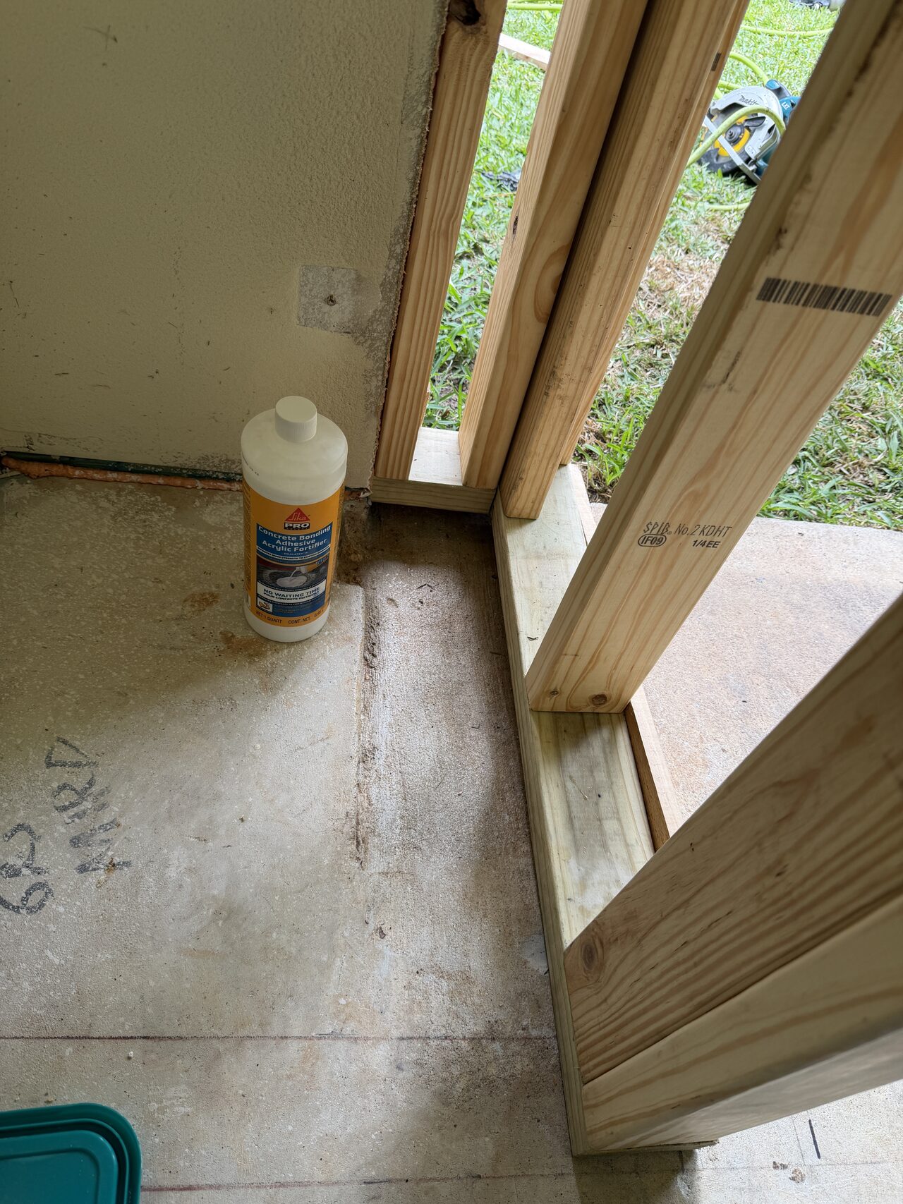 Interior door opening with framing and concrete floor transition checked before casing or threshold work for a Joel Hodge project.