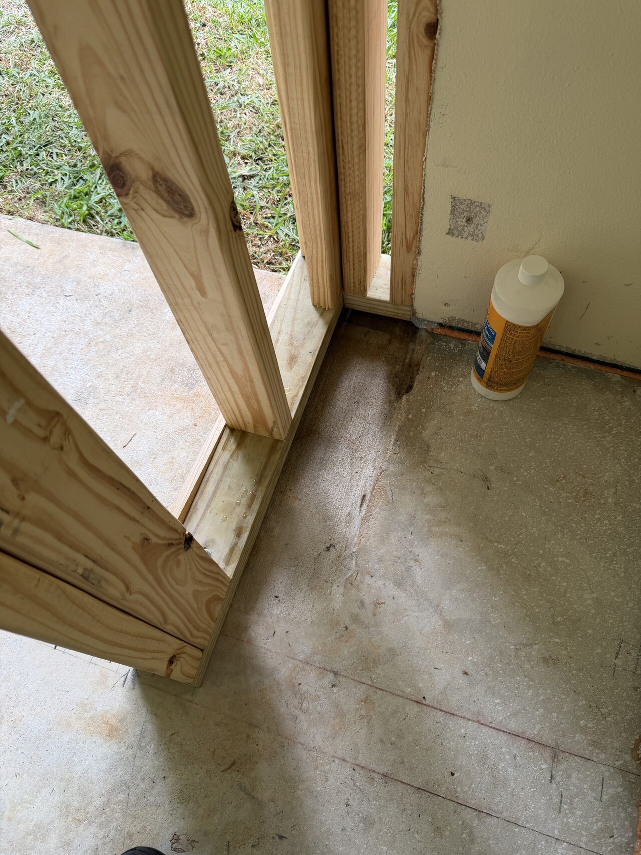 Rough door opening documented with framing, threshold, and slab condition visible for a Joel Hodge project.