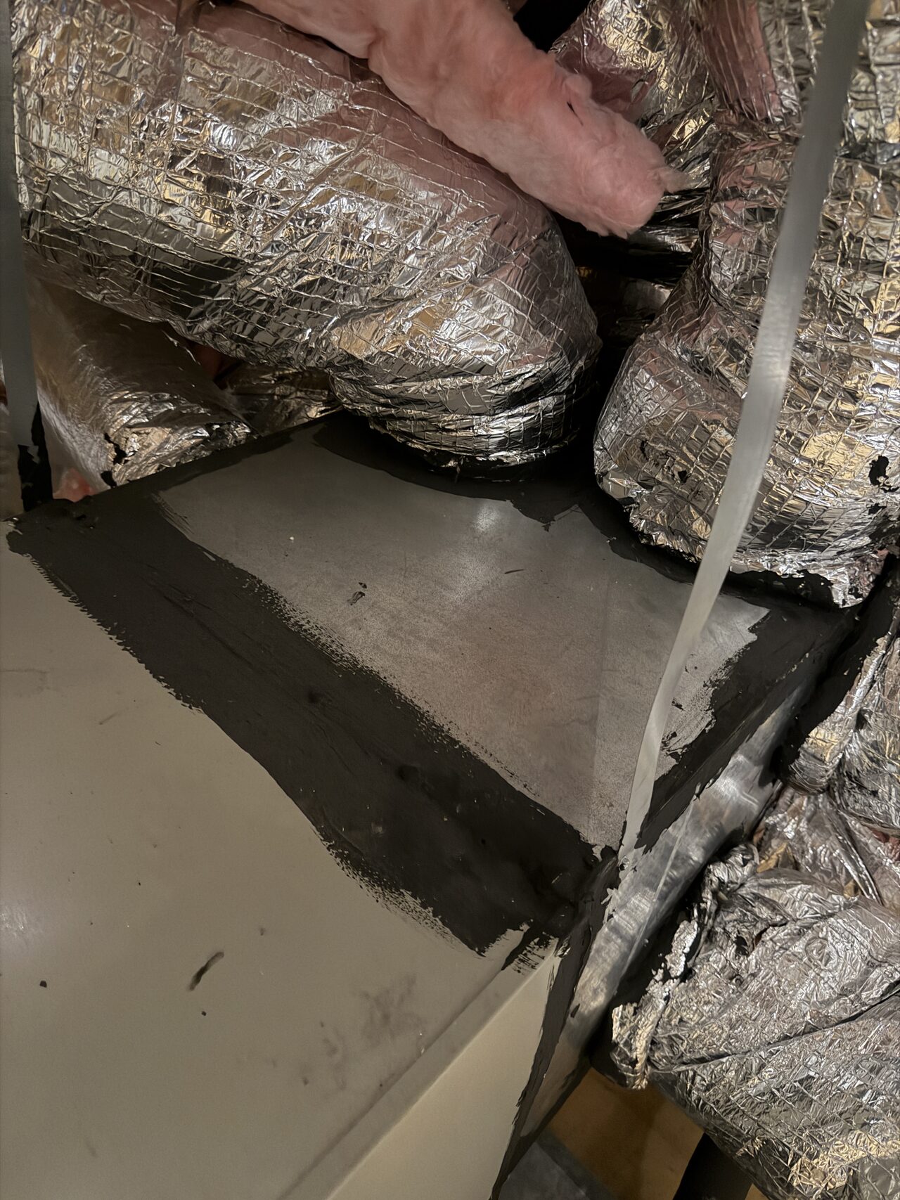 Close-up of slab edge and threshold repair area before final trim or door fit for a Joel Hodge project.
