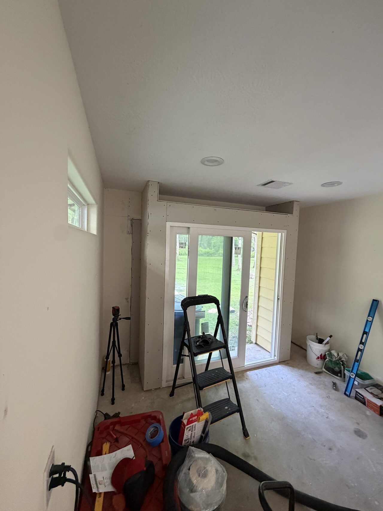 Interior room with tools and protection staged while trim and opening details were being prepared for a Joel Hodge project.