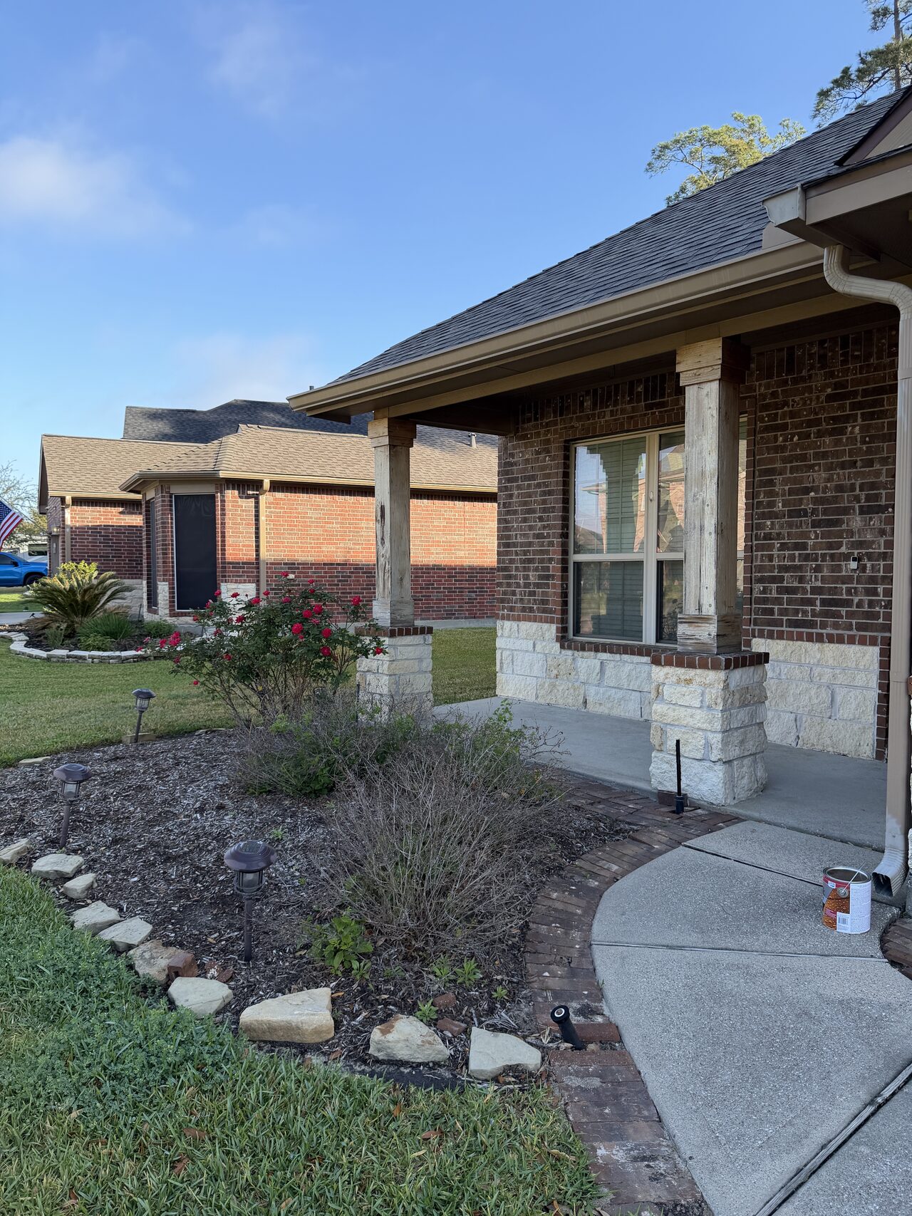 Wider porch and roofline view showing column placement and the exterior entry area for a Joel Hodge project.