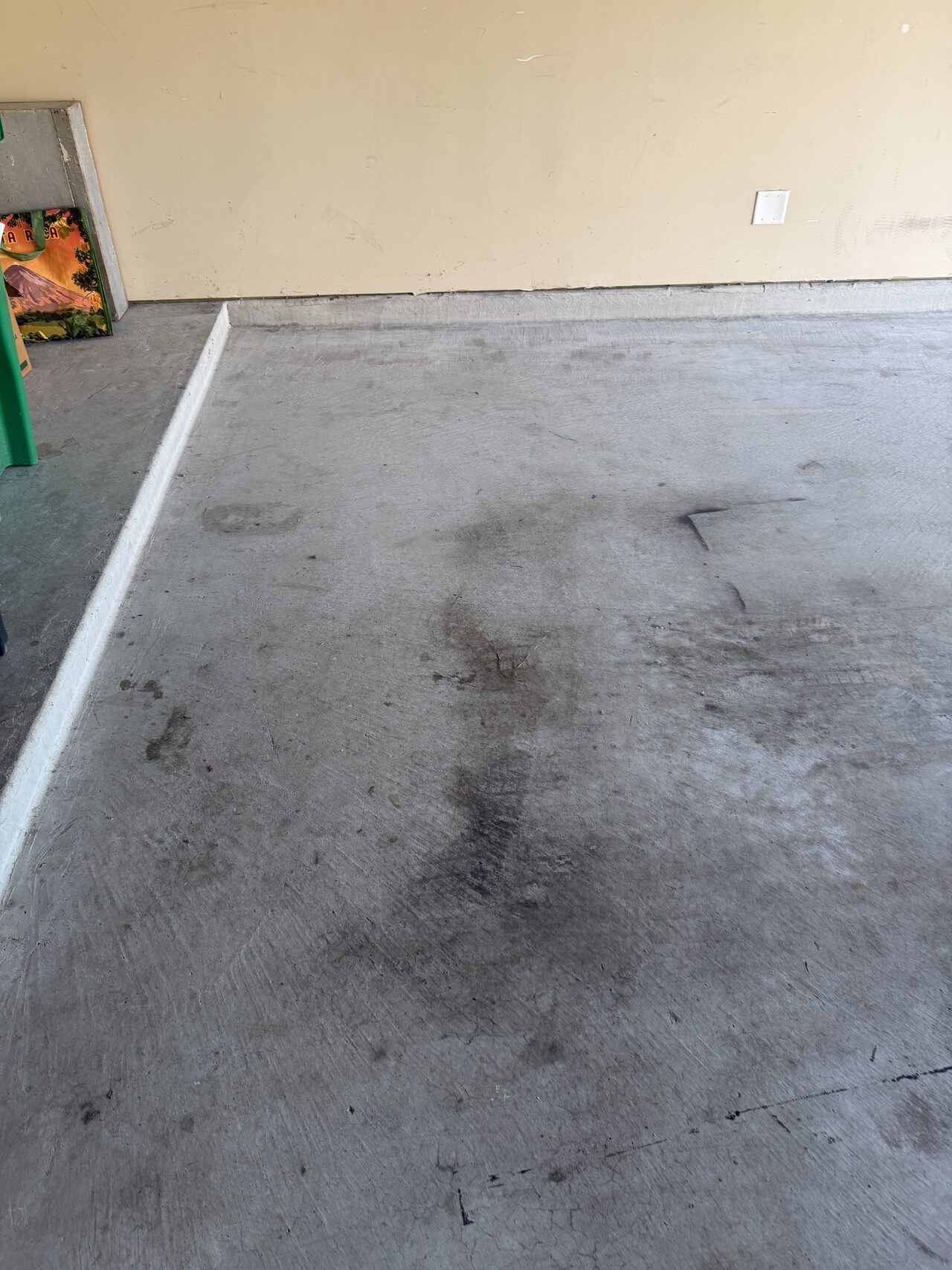 Garage and concrete work area documented after setup for door refinishing and cleanup coordination for a Joel Hodge project.