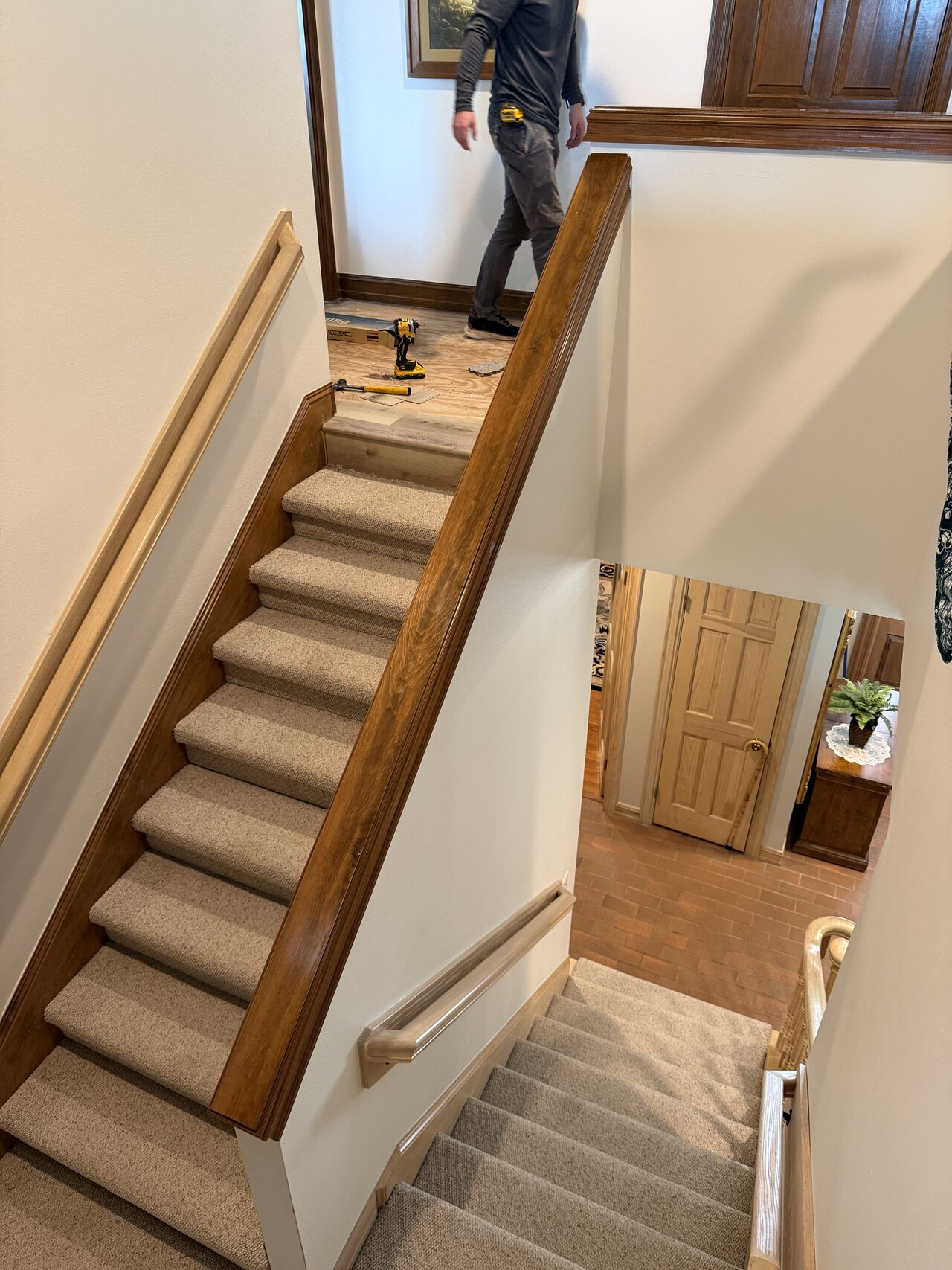 Completed stair view showing treads, risers, handrail, and wall trim after refresh work for a Joel Hodge project.