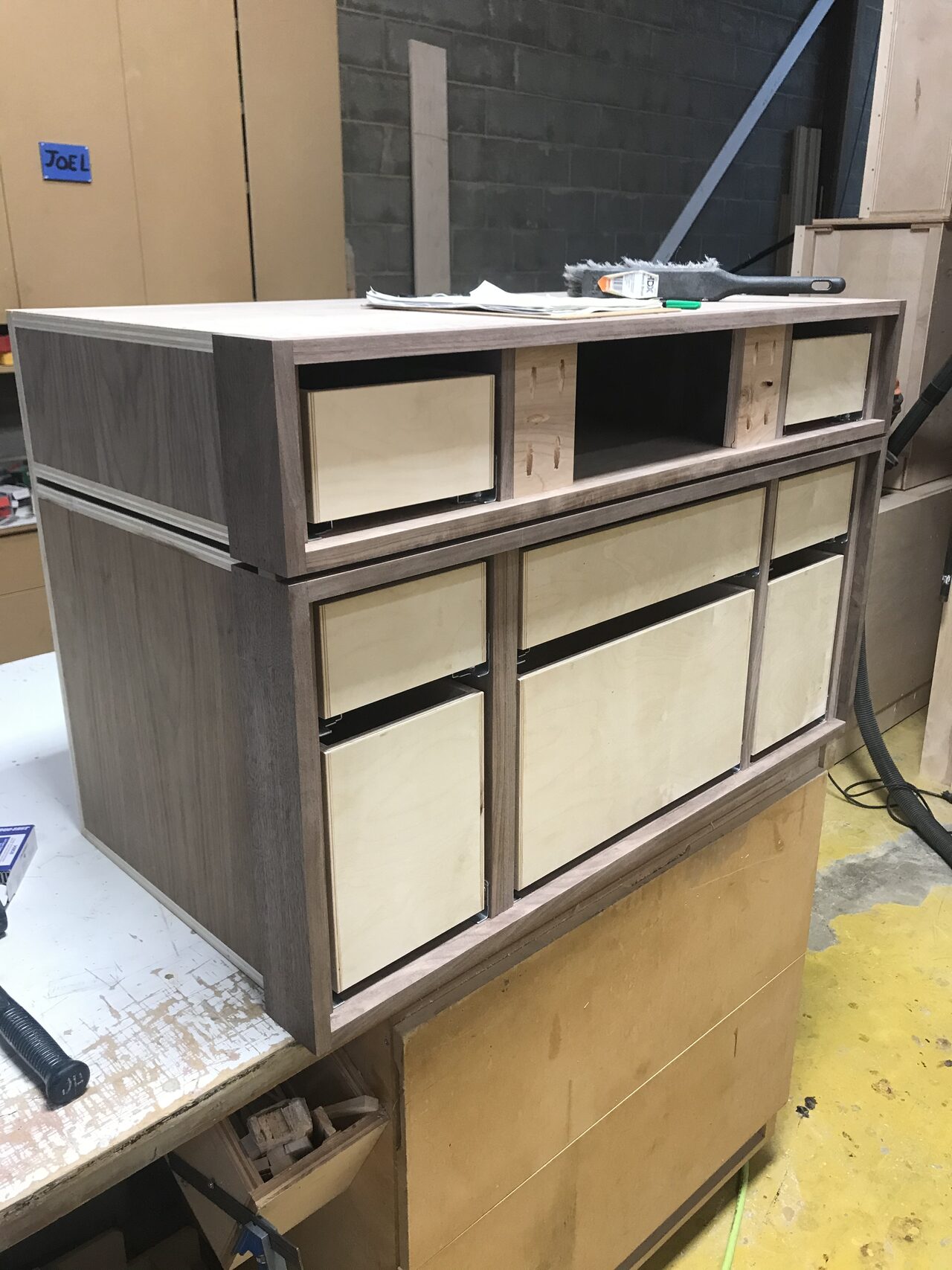 Drawer and door front layout staged on the cabinet face to verify reveal spacing for a Joel Hodge project.