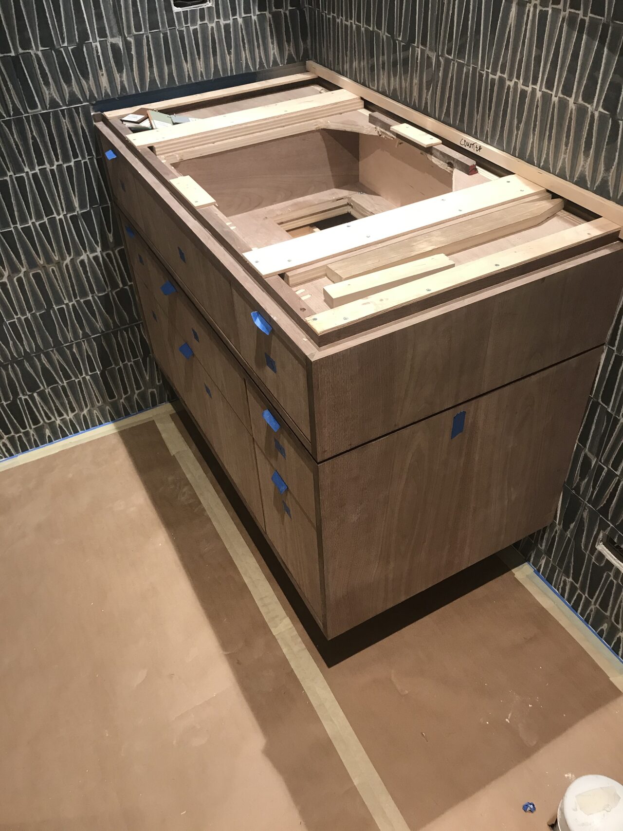 Bathroom vanity top opening and drawer fronts reviewed after the cabinet was set in place for a Joel Hodge project.