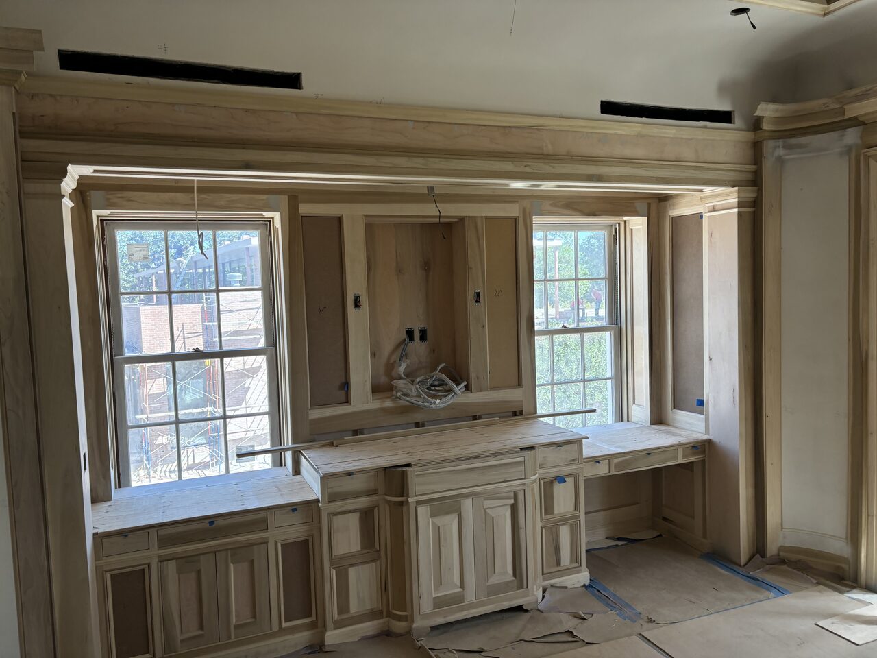Window wall cabinetry and paneling checked for symmetry, counter height, and trim alignment for a Joel Hodge project.