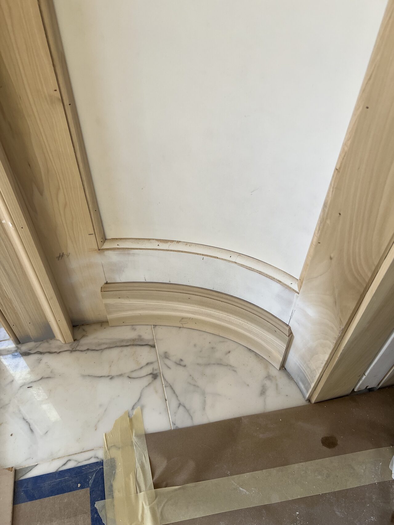 Close-up of curved trim and base transition where the wall paneling meets the floor for a Joel Hodge project.