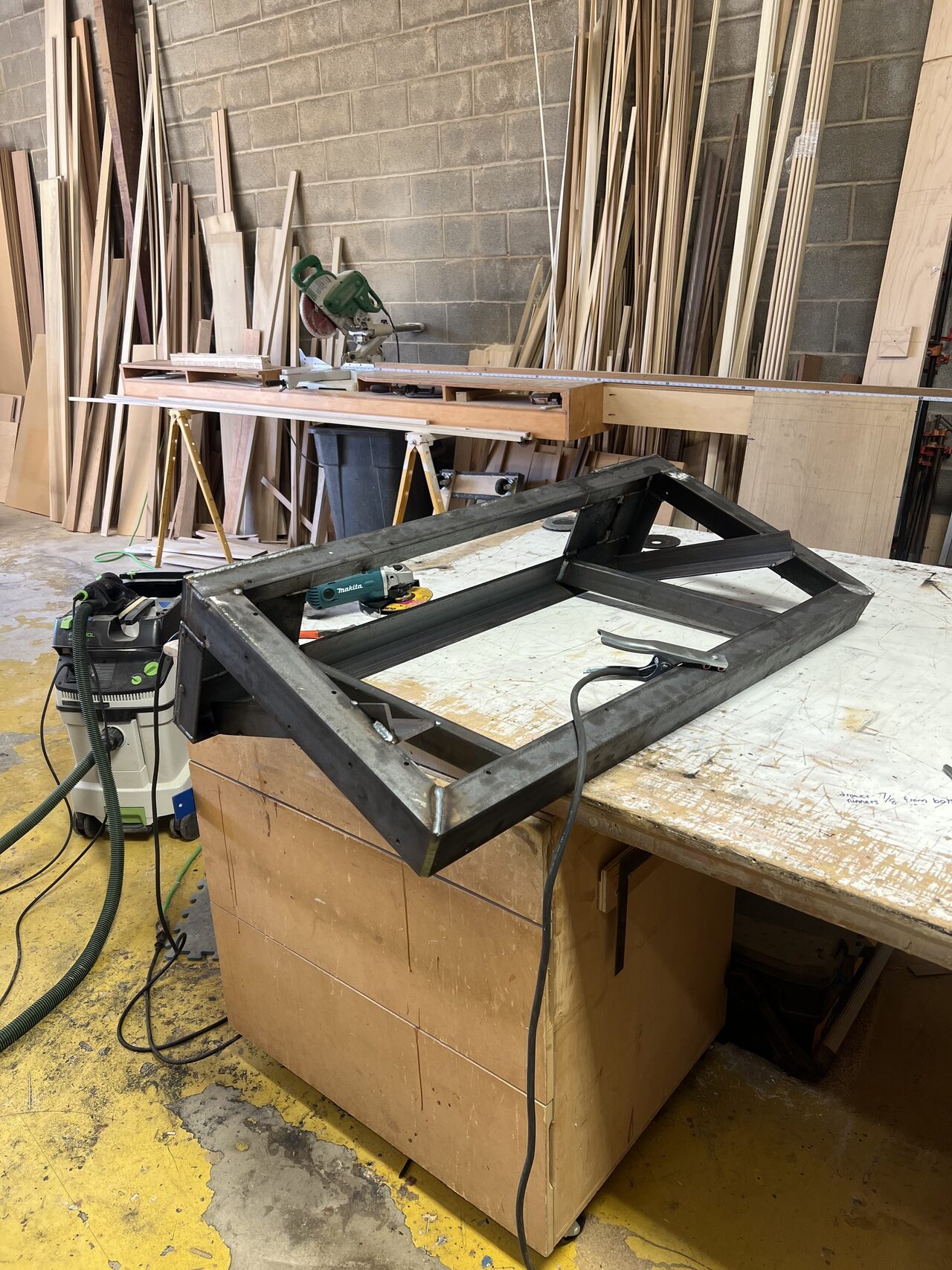 Metal frame or support component staged on the shop bench for built-in coordination for a Joel Hodge project.