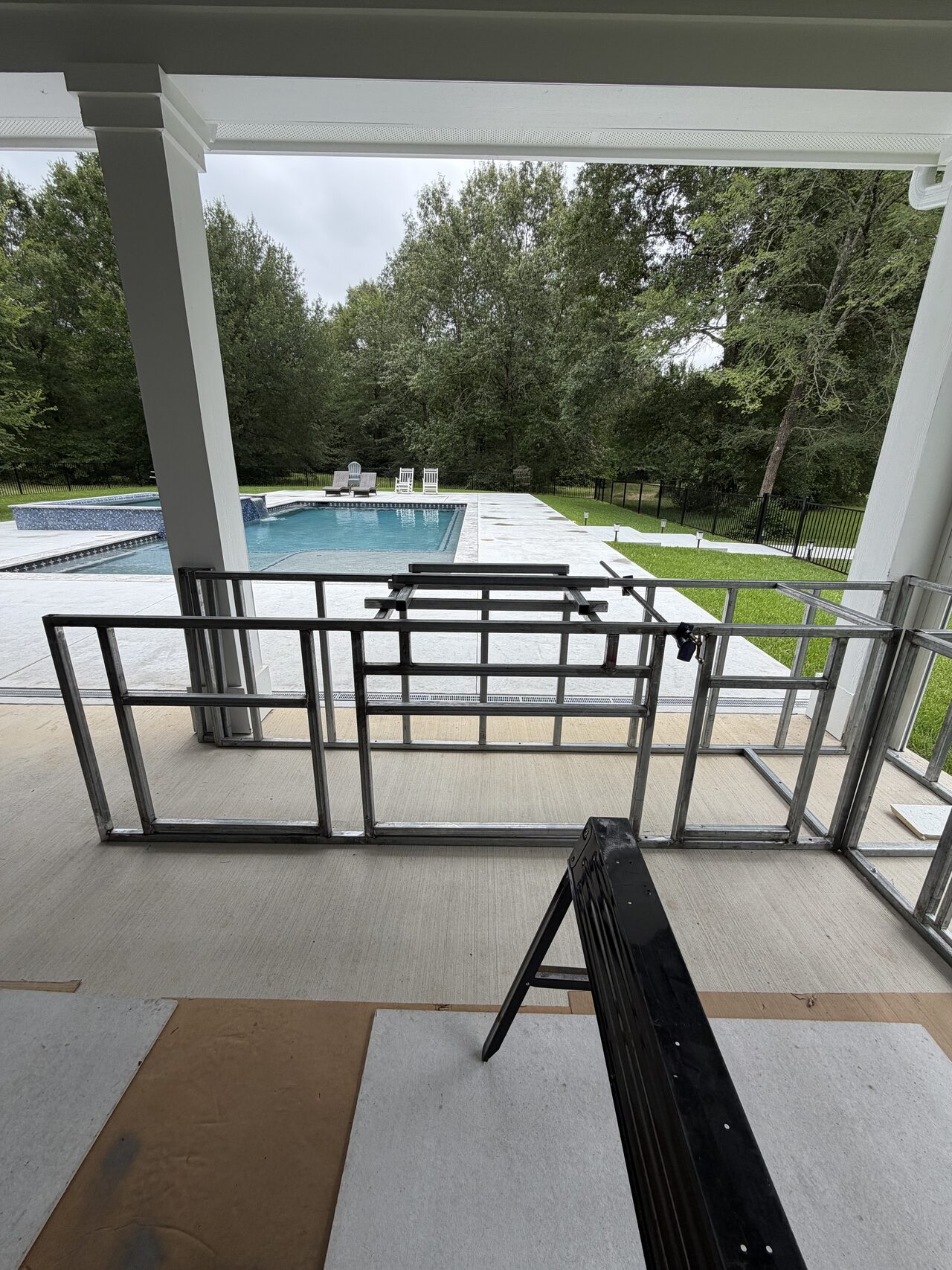 Patio railing line reviewed from the porch toward the pool to confirm layout and sight lines for a Joel Hodge project.