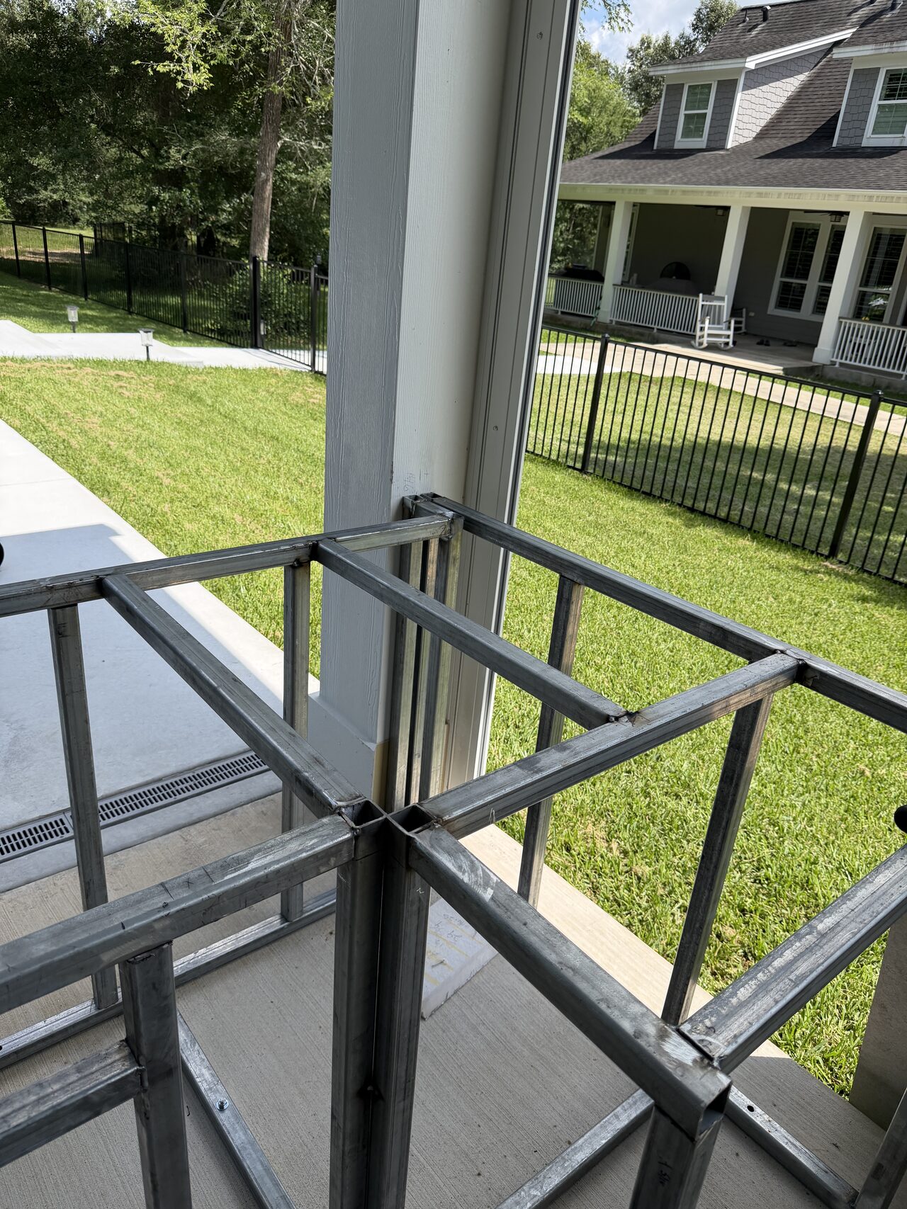 Railing corner and frame alignment reviewed around the patio edge and lawn side for a Joel Hodge project.