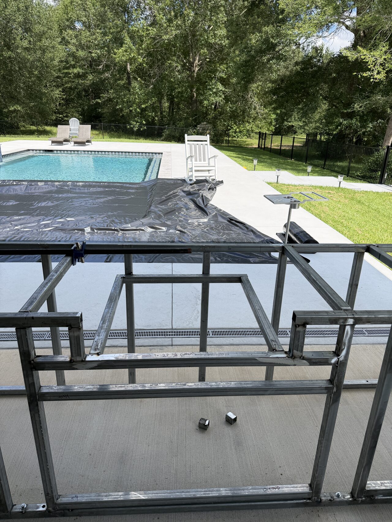 Railing frame and panel placement reviewed against the pool and yard sight line for a Joel Hodge project.