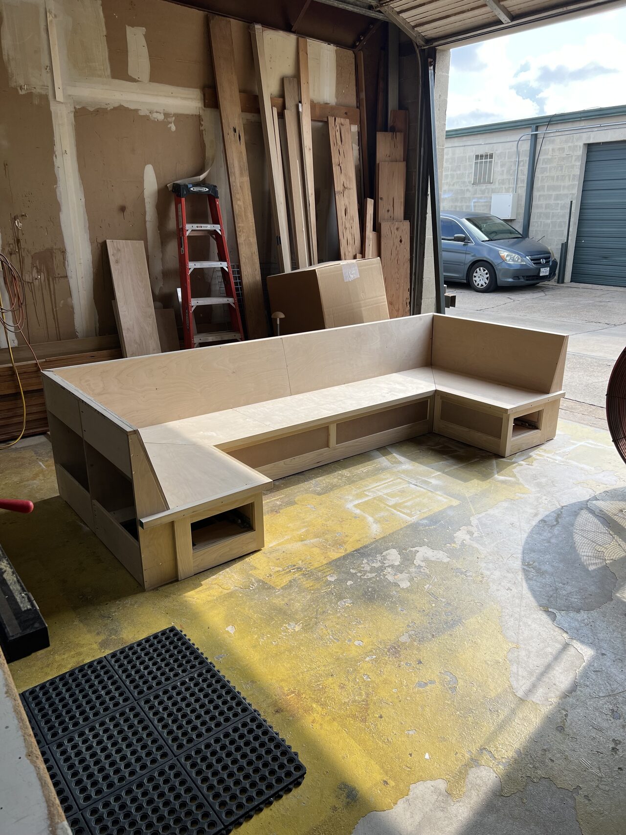 L-shaped low storage base checked for corner fit and open cubby alignment for a Joel Hodge project.