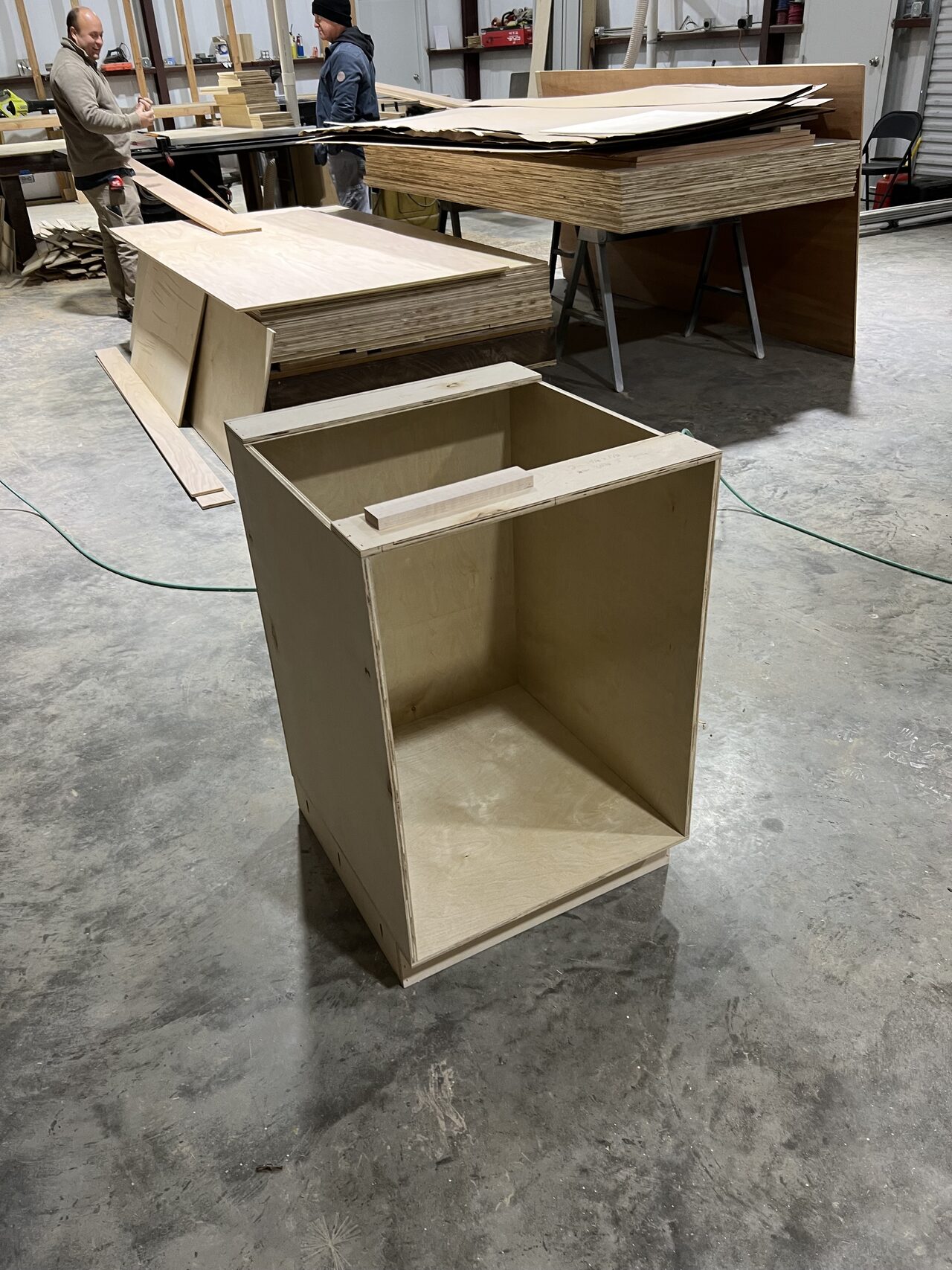 Individual cabinet boxes staged upright after assembly for sanding and finish preparation for a Joel Hodge project.