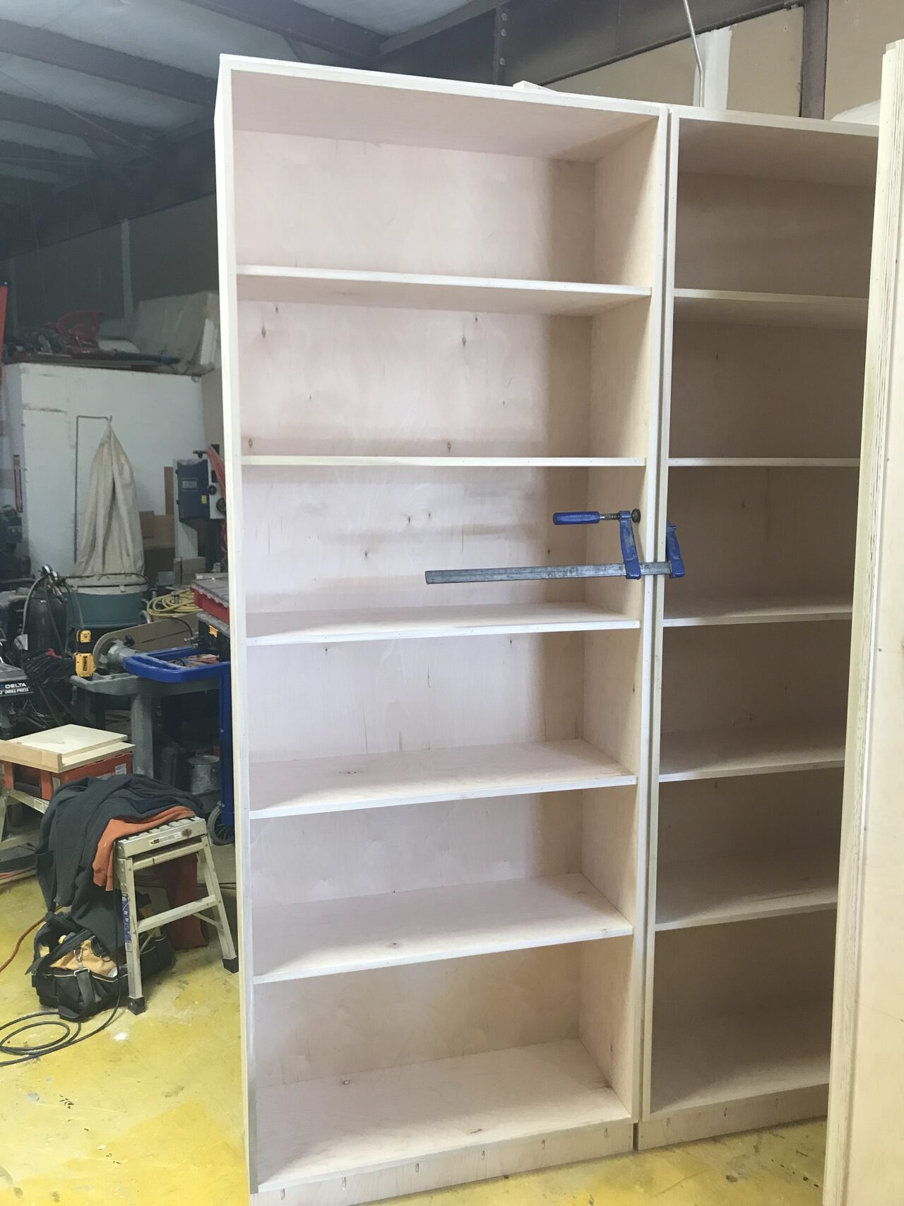 Tall open shelving cabinet assembled in the shop before finish trim and site installation for a Joel Hodge project.