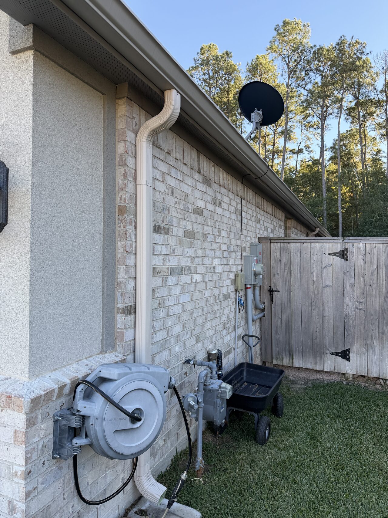 Side-yard wall, utility, and drainage area reviewed before concrete and walkway planning for a Joel Hodge project.