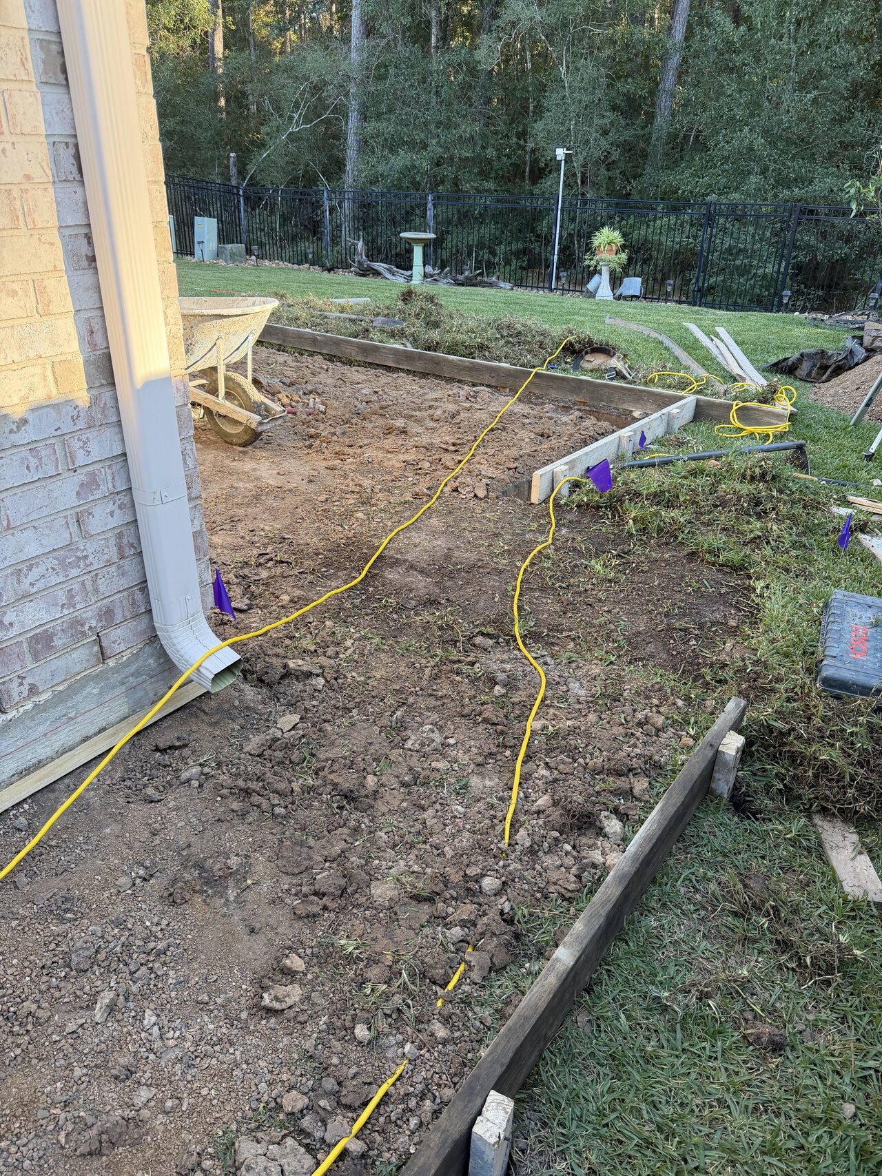 Backyard grade and layout string documented before forming the side-yard concrete path for a Joel Hodge project.