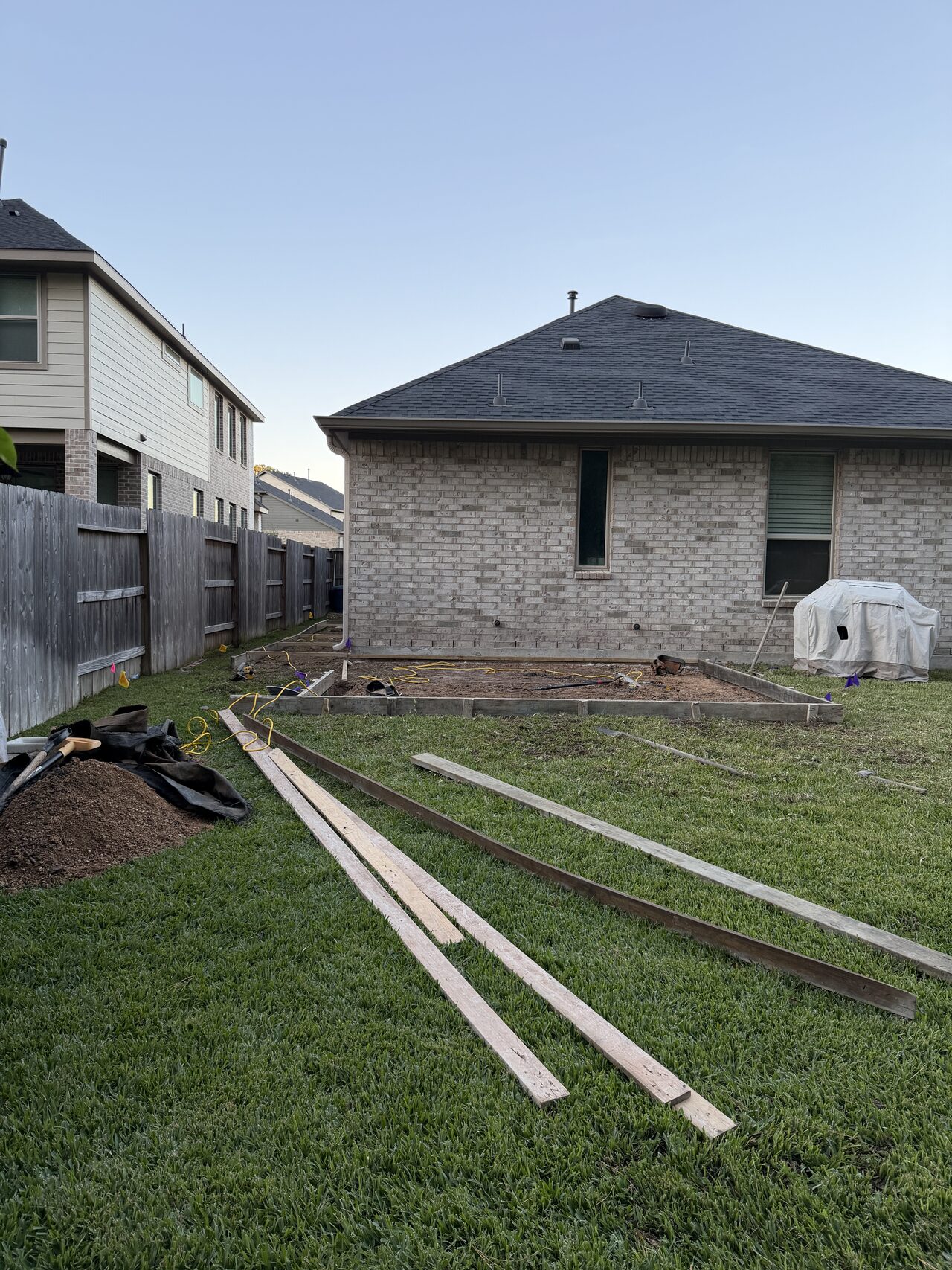 Long side-yard path layout with boards and yard access checked before concrete placement for a Joel Hodge project.