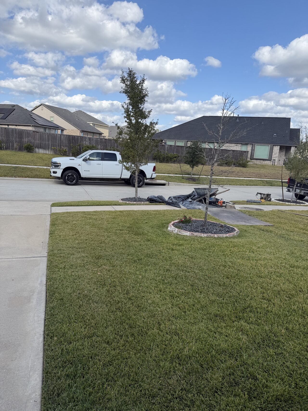 Front yard and driveway approach documented for material access and concrete work staging for a Joel Hodge project.