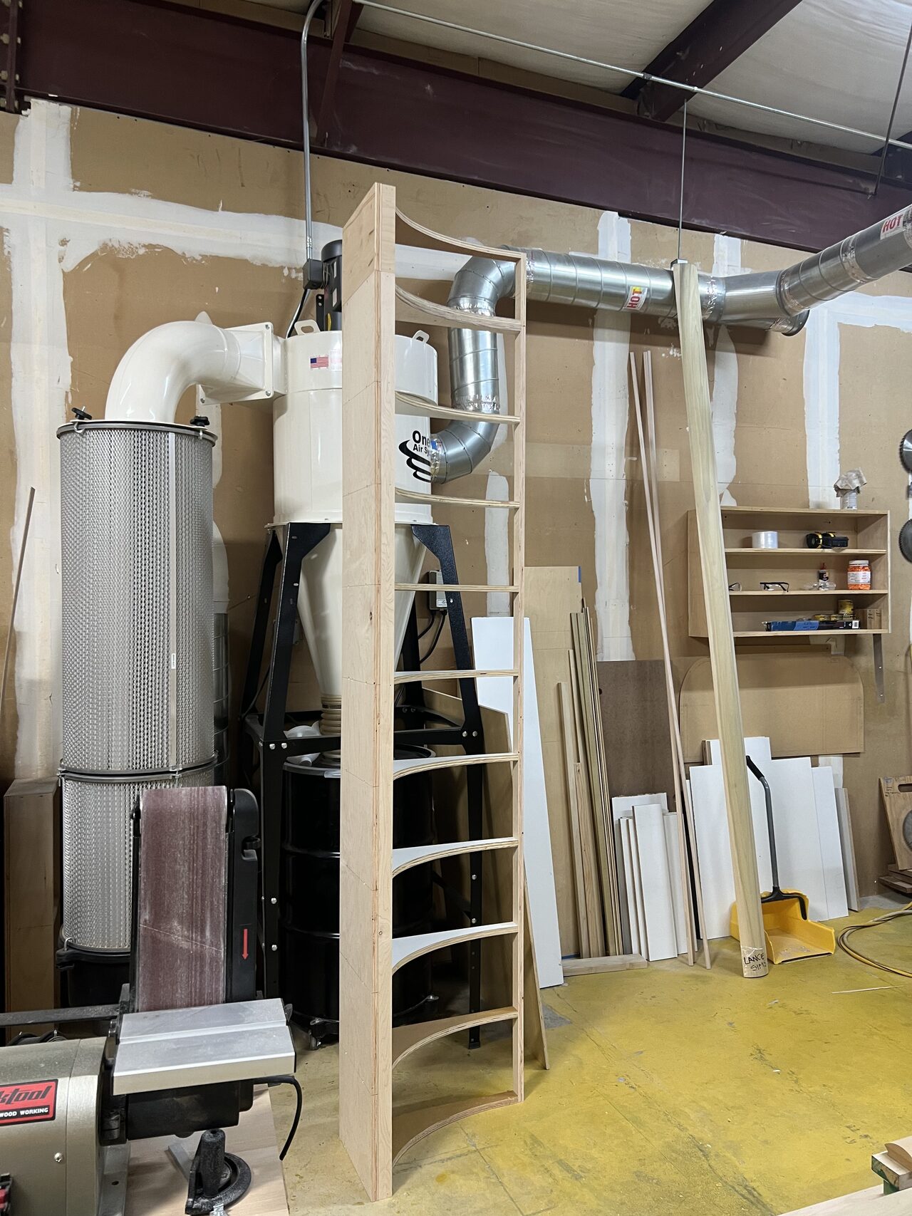 Tall cabinet parts and shop storage area documented before small cabinet fitting began for a Joel Hodge project.