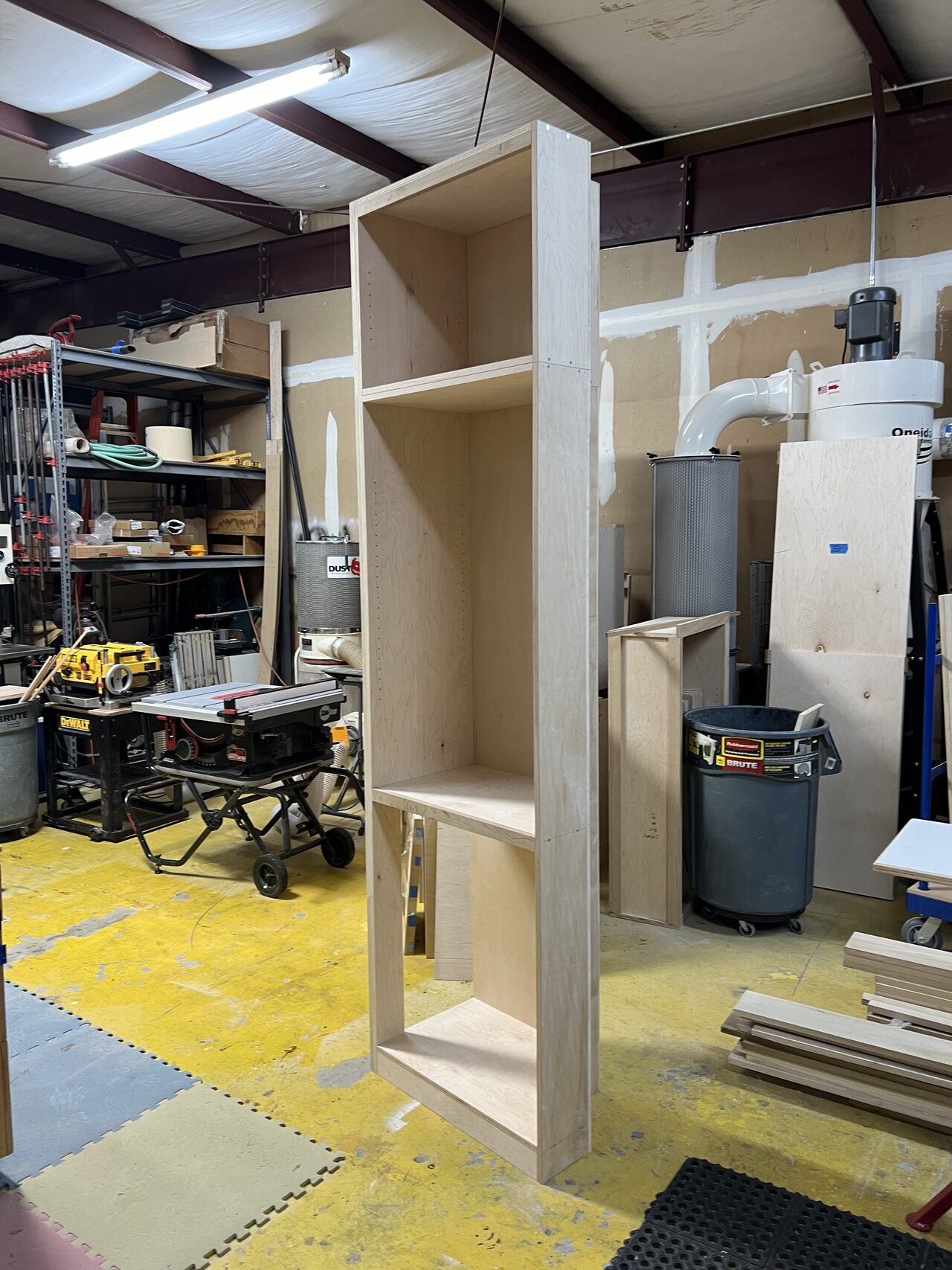 Tall cabinet shell standing in the shop while depth and opening dimensions were checked for a Joel Hodge project.