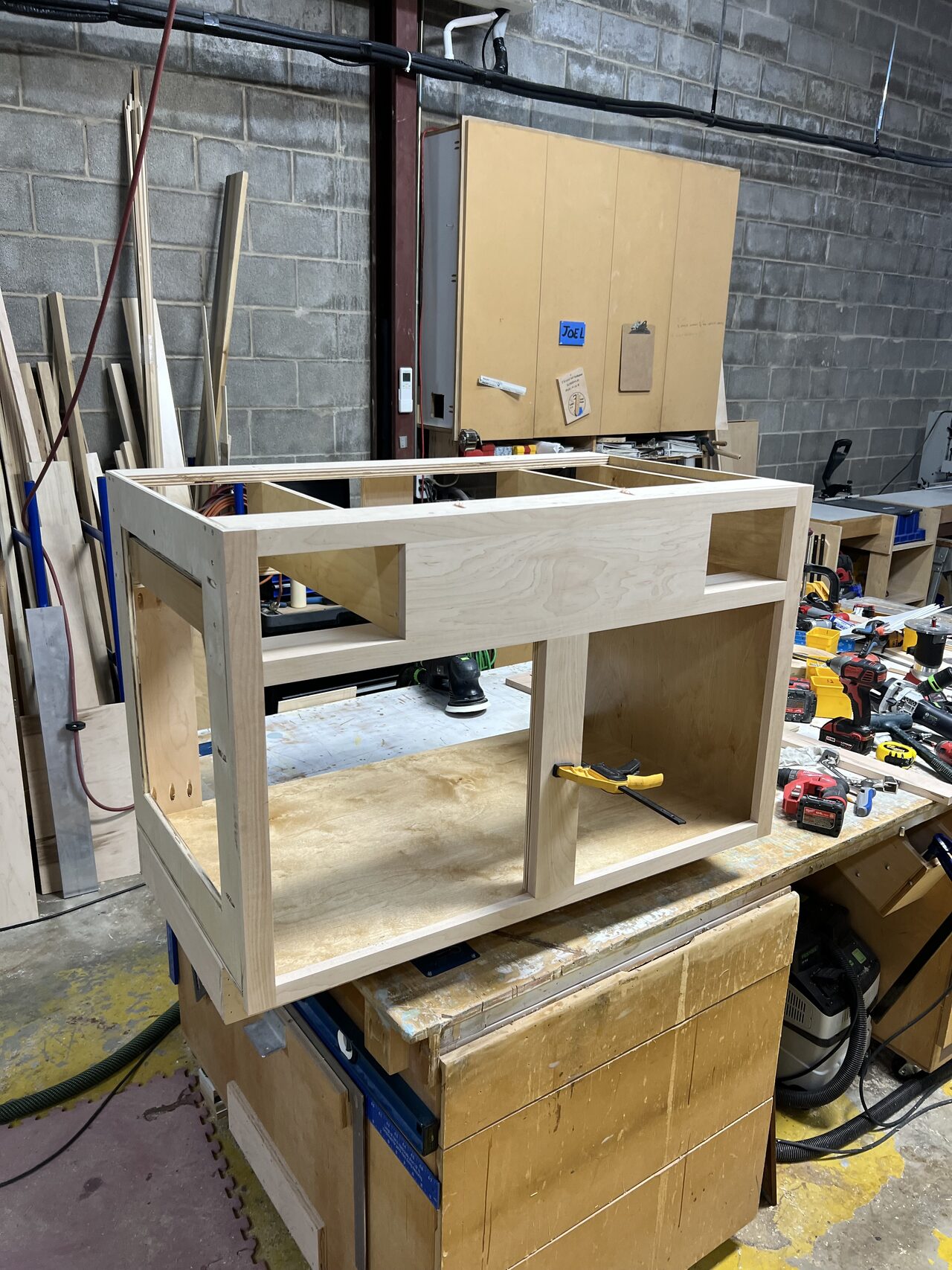 Open cabinet frame on the bench reviewed for drawer opening and face-frame layout for a Joel Hodge project.