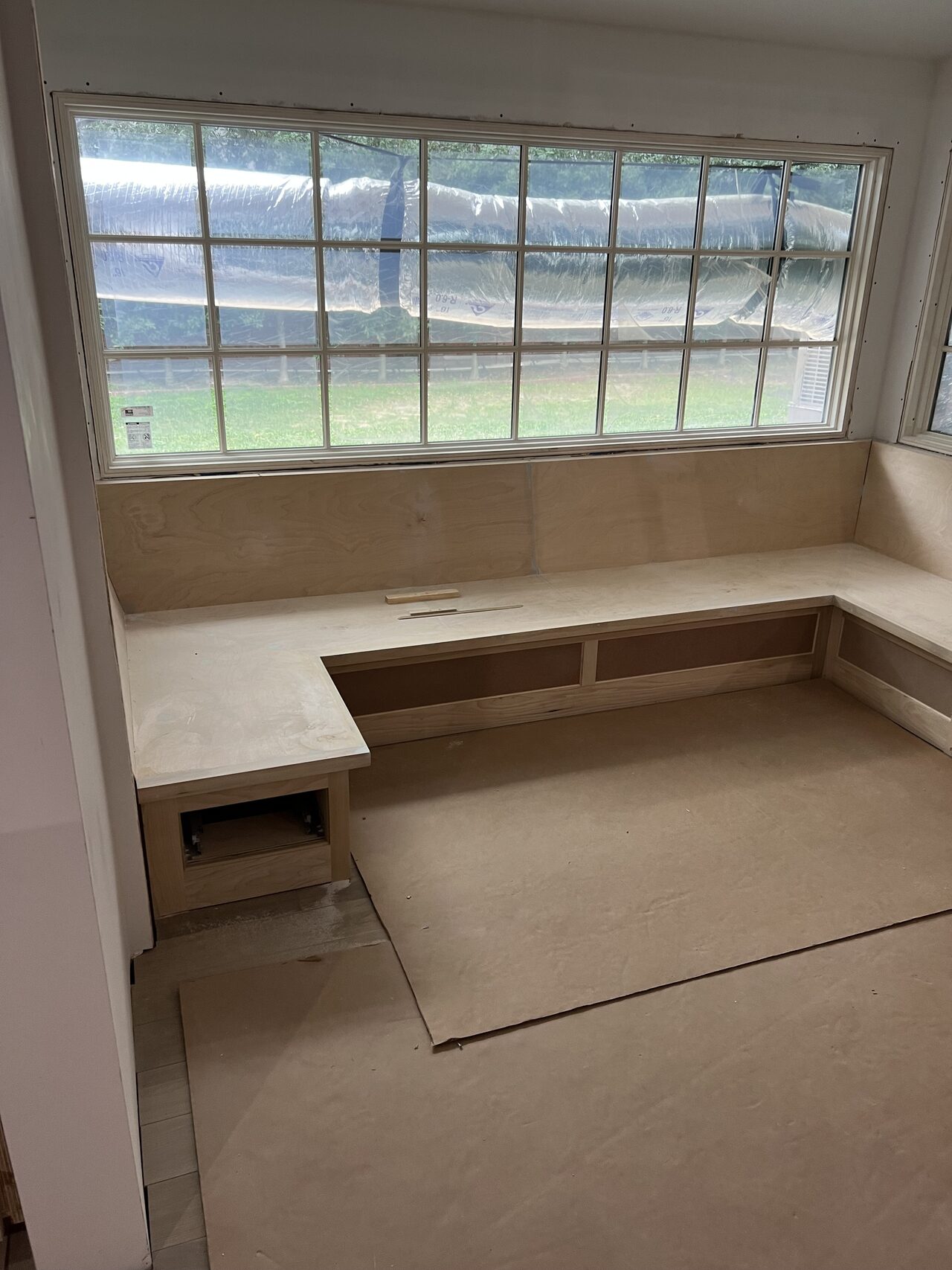 Window-seat bench run checked for wall-to-wall fit and consistent base cabinet depth for a Joel Hodge project.