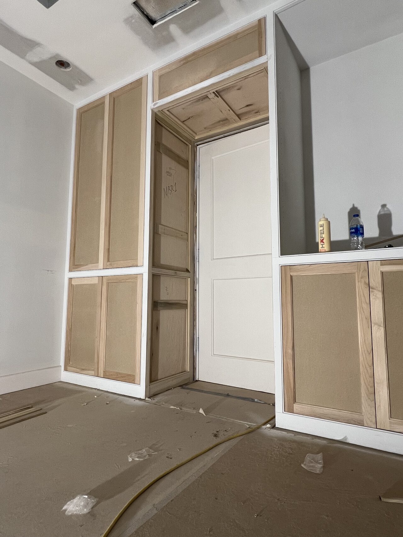 Tall built-in frame installed in the niche before final trim, doors, or panel finish for a Joel Hodge project.
