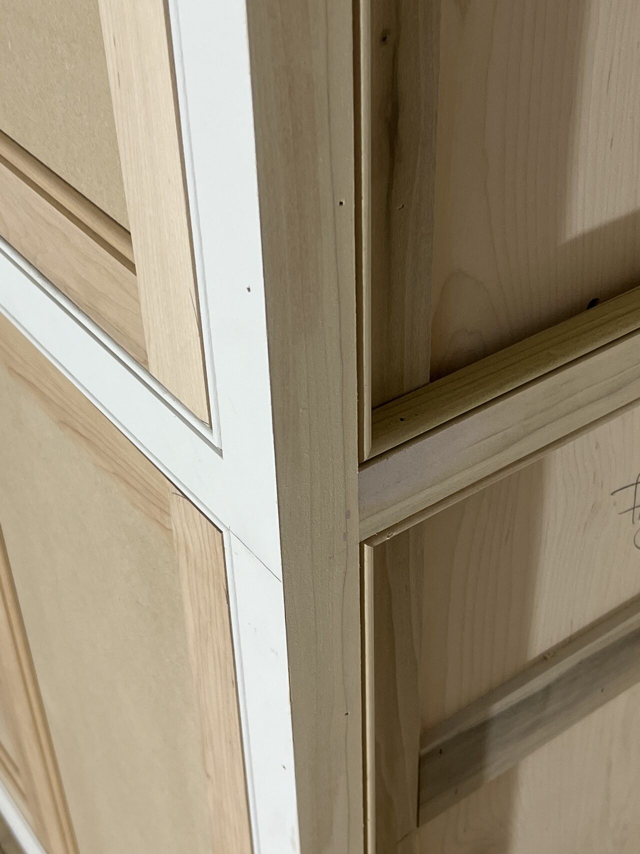 Close-up of stile and inset panel alignment where the niche cabinet face meets trim for a Joel Hodge project.
