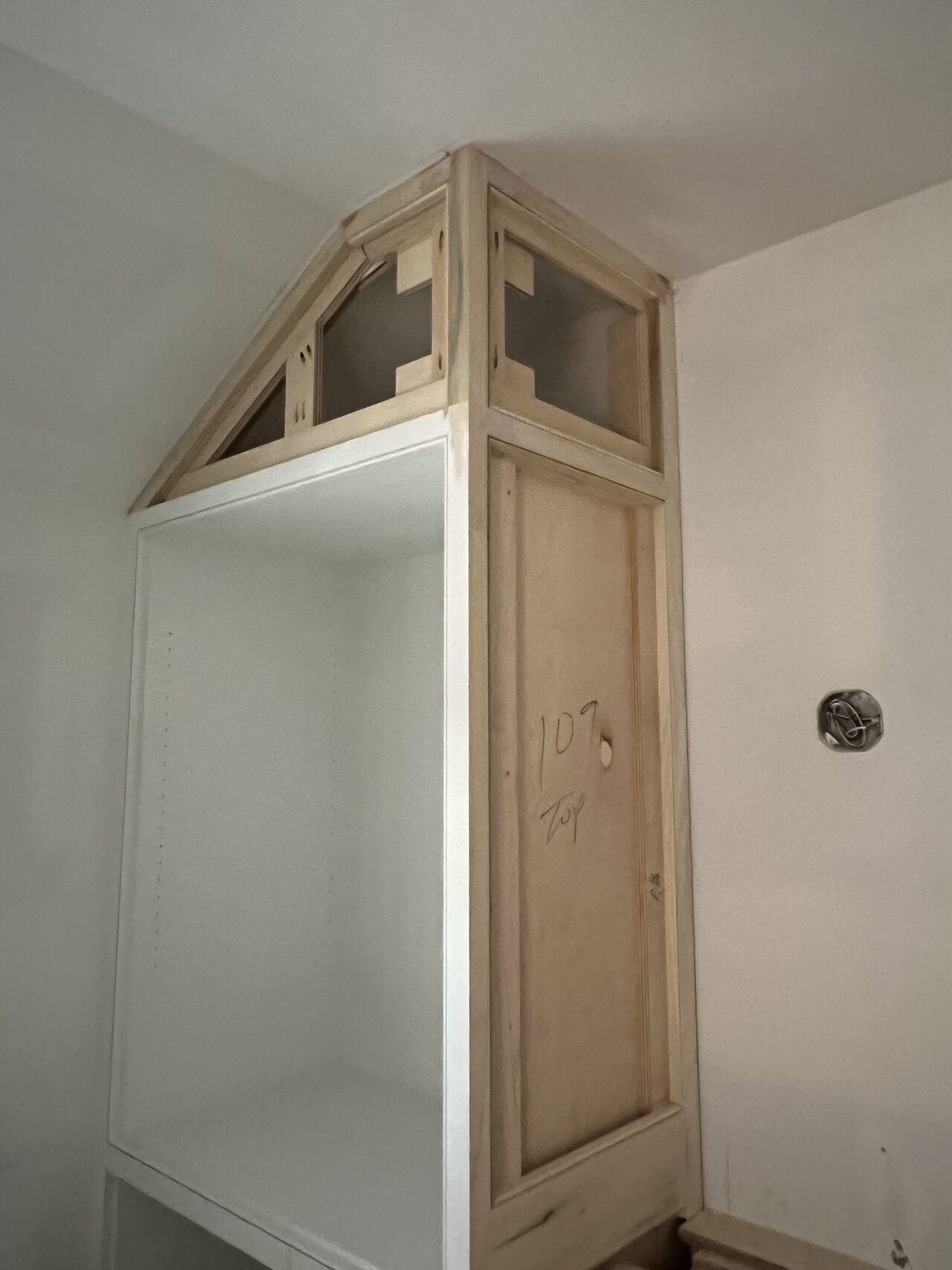 Tall niche cabinet with upper angled section checked for wall fit and reveal consistency for a Joel Hodge project.