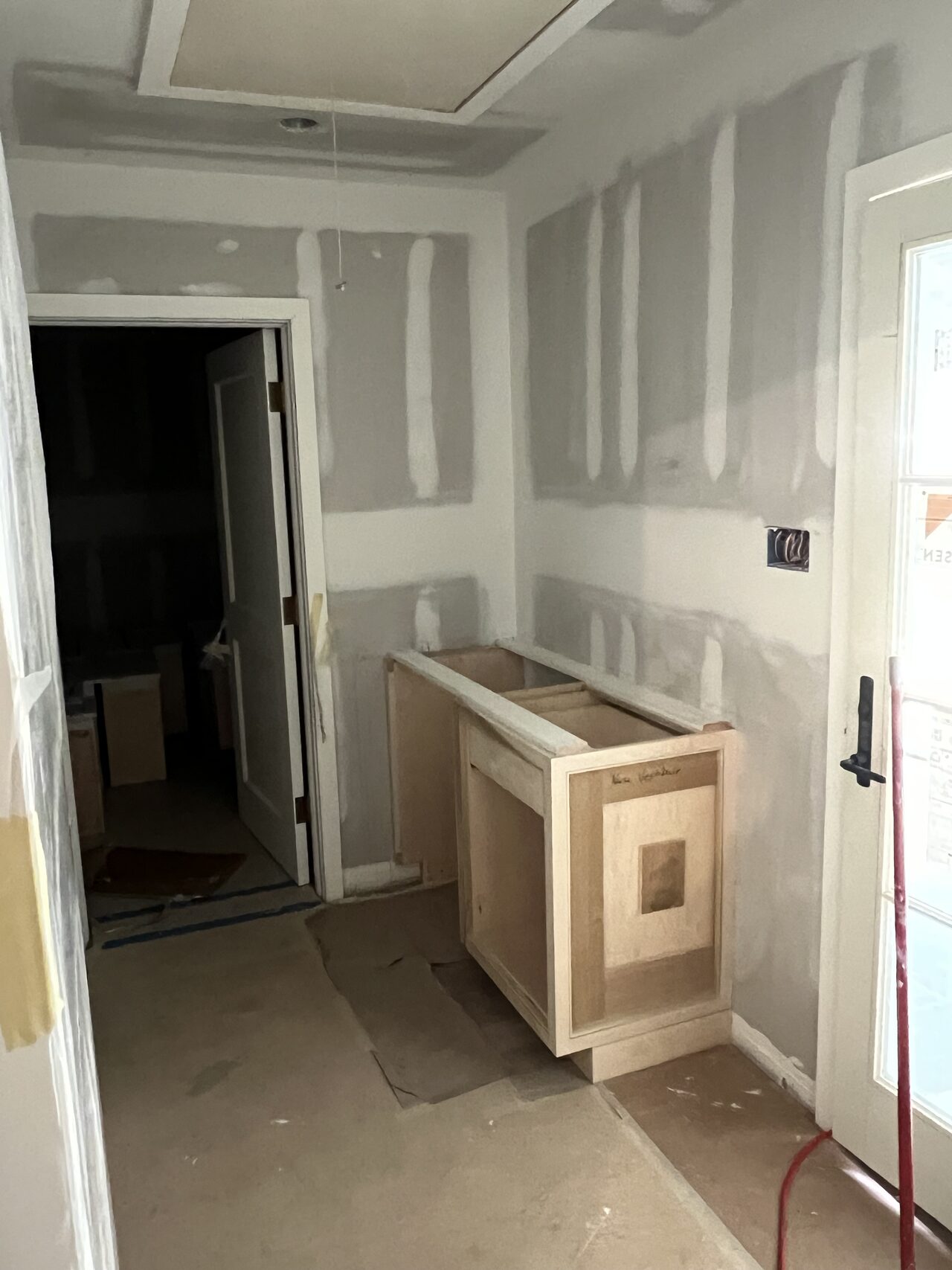 Shop-built cabinet and panel parts staged in the room before final installation in the niche for a Joel Hodge project.